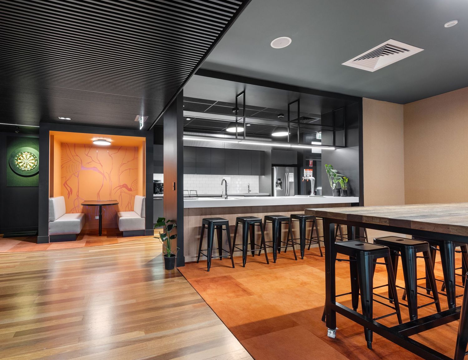 Interior photograph of a restaurant fit-out with timber bar and pendant lighting.