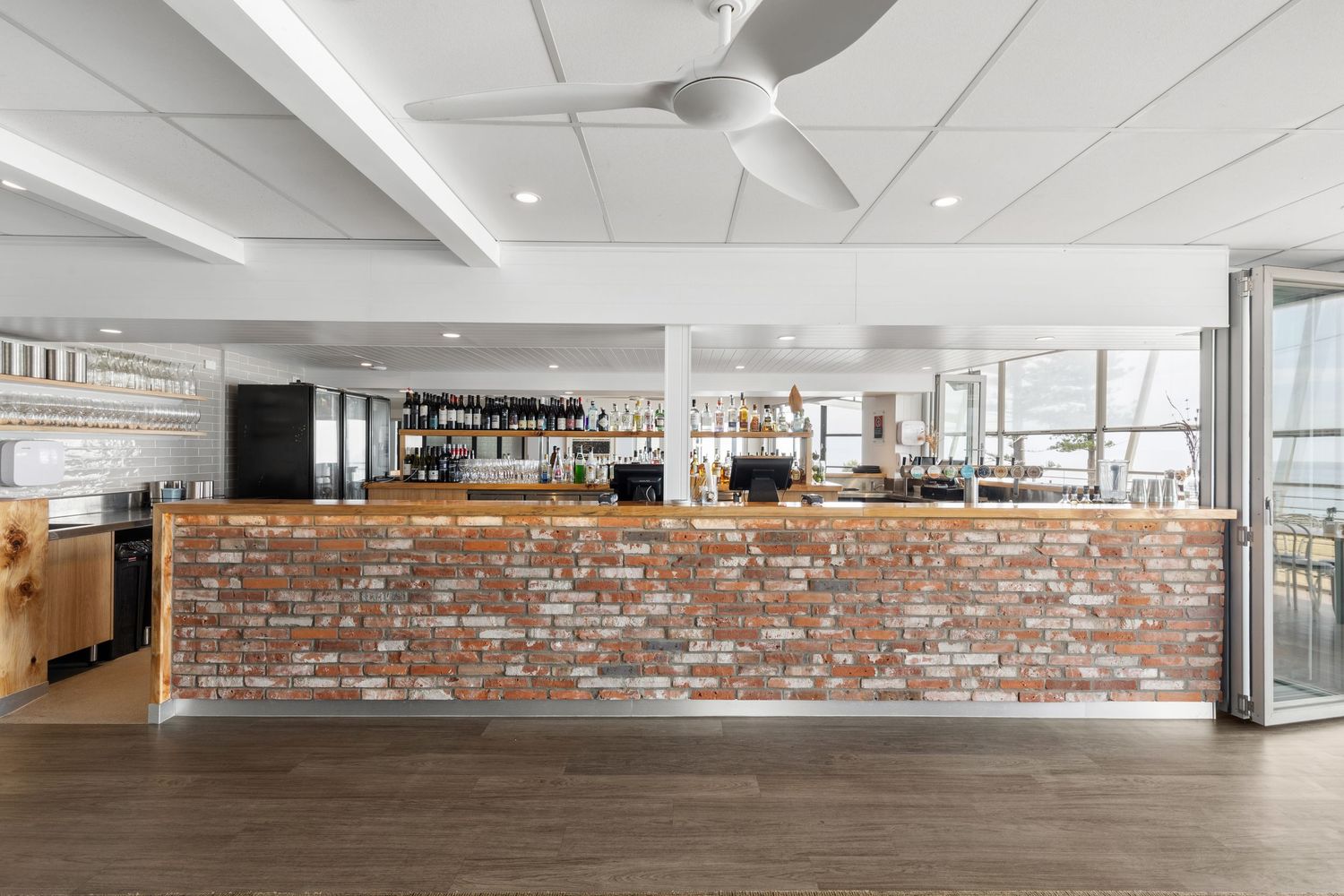 Interior photograph of a cafe fit-out with exposed brick counter.