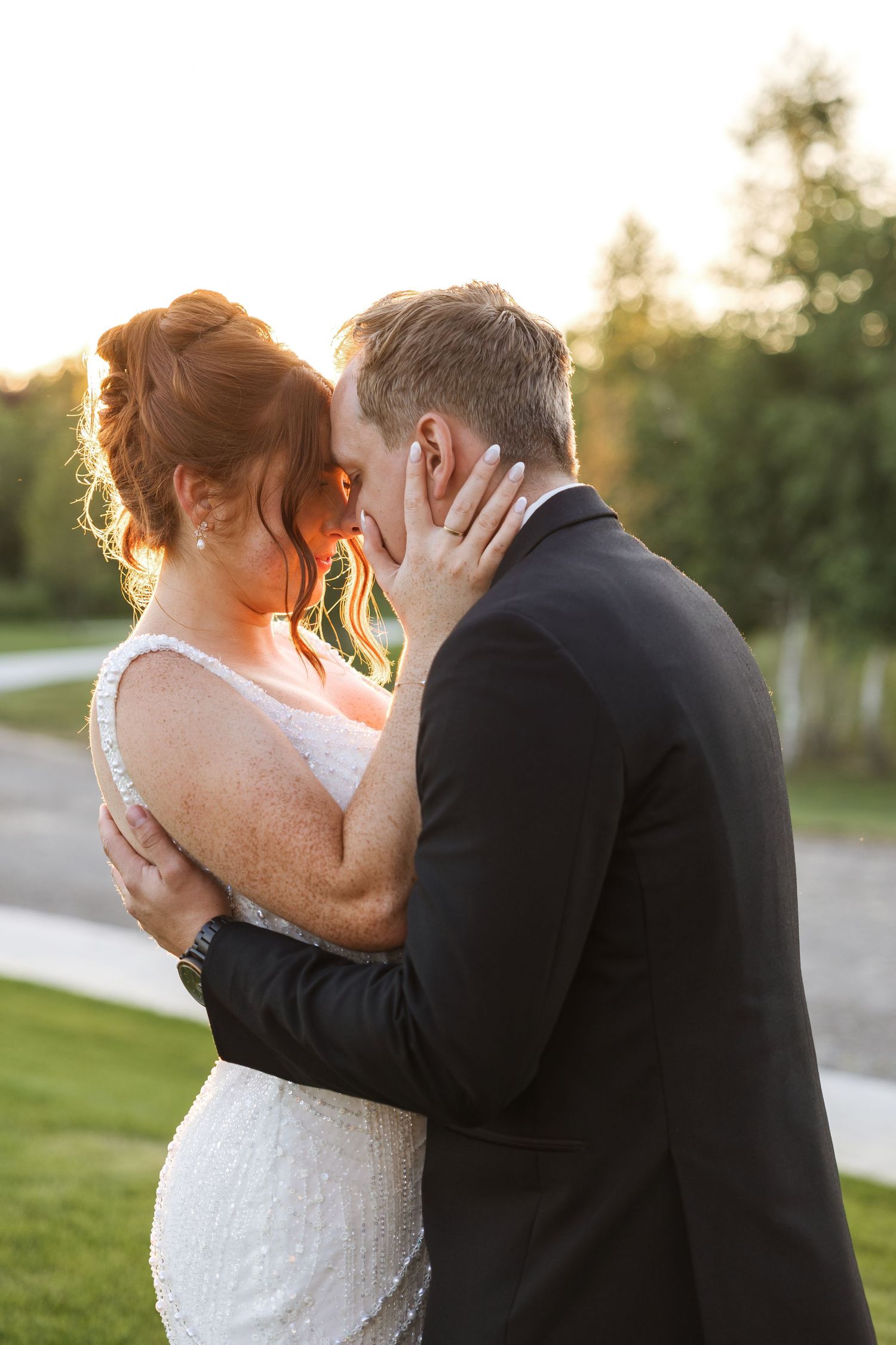 Couple embraces closely during golden hour at White Birch Wedding Barn in Cement City Michigan by Rachel Martinez Photography, Michigan wedd