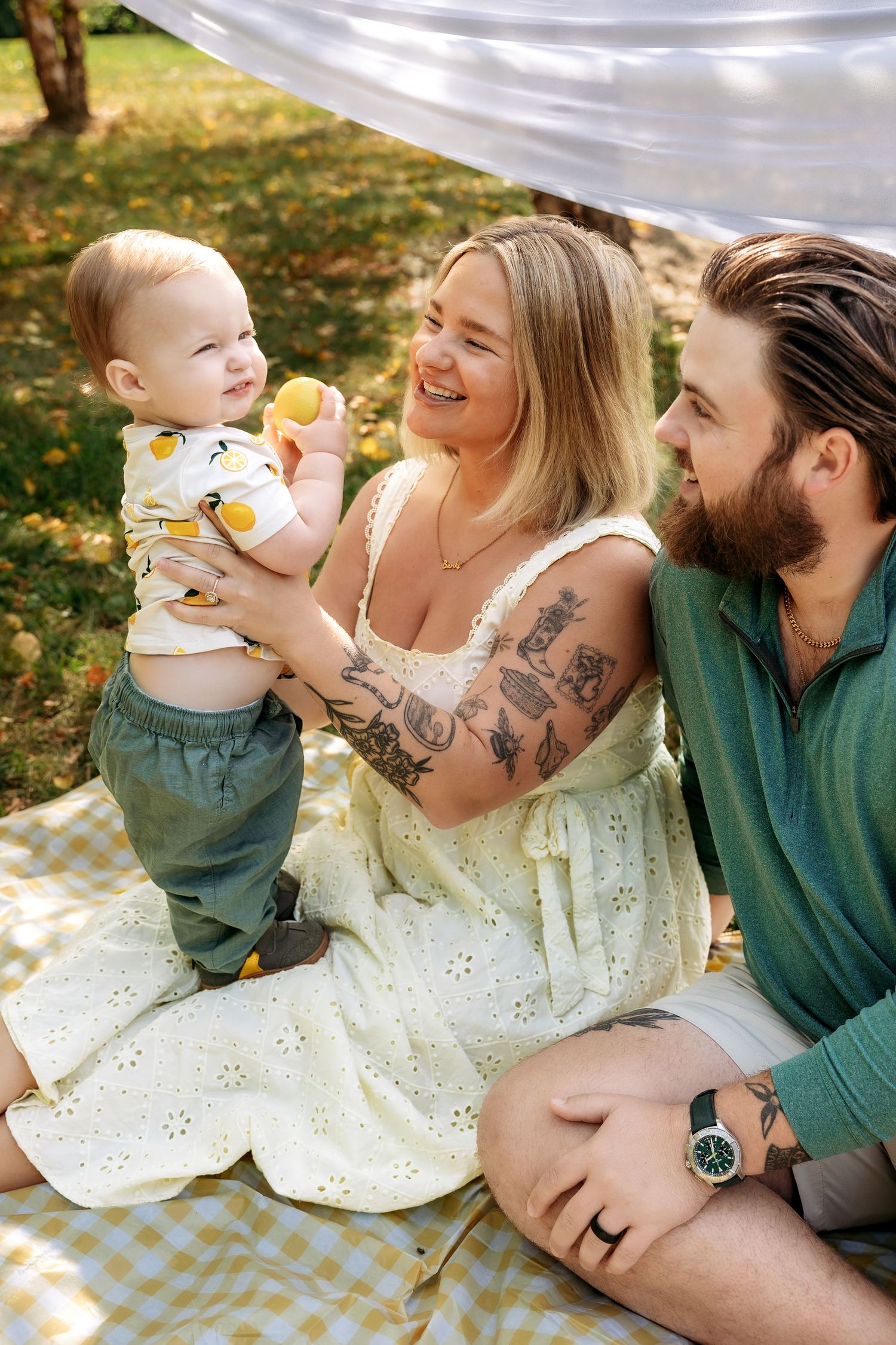 Family of three poses during mini session in Novi Michigan by Rachel Martinez Photography