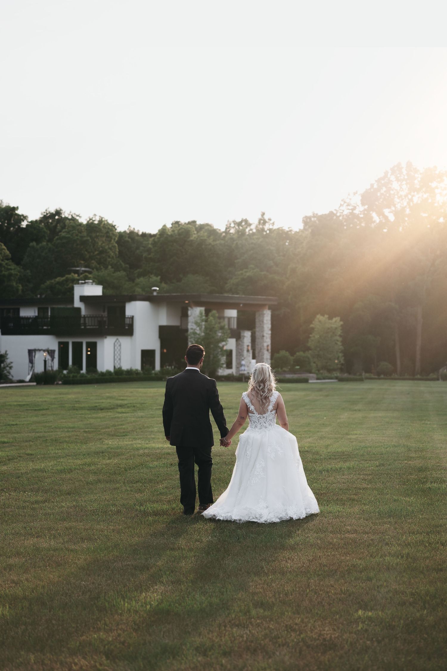 Couple walks in the golden hour light at Hidden Grove Estate by Rachel Martinez Photography, Michigan wedding photographer