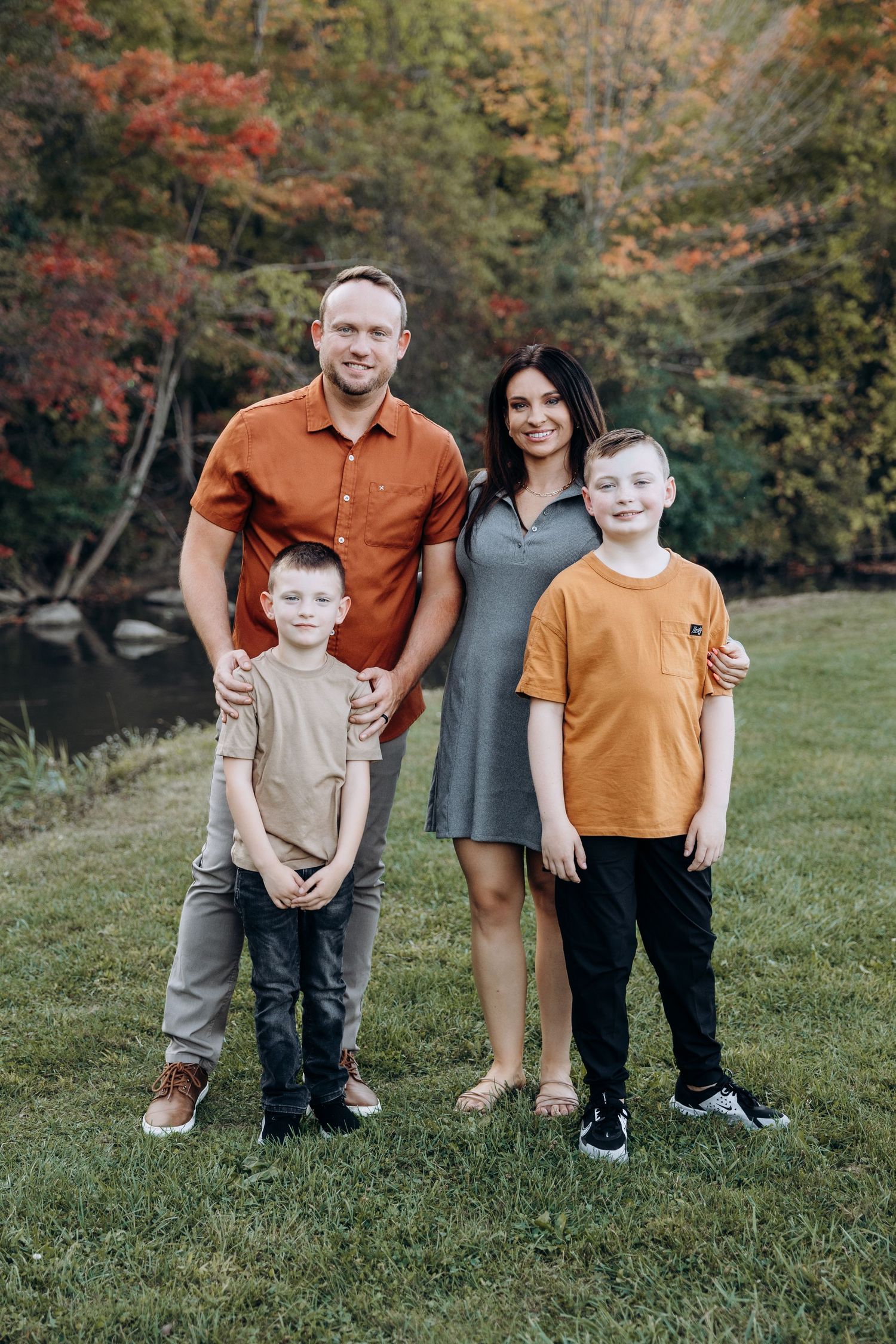 Family of four poses along the water in Northville Michigan by Rachel Martinez Photography, Michigan photographer