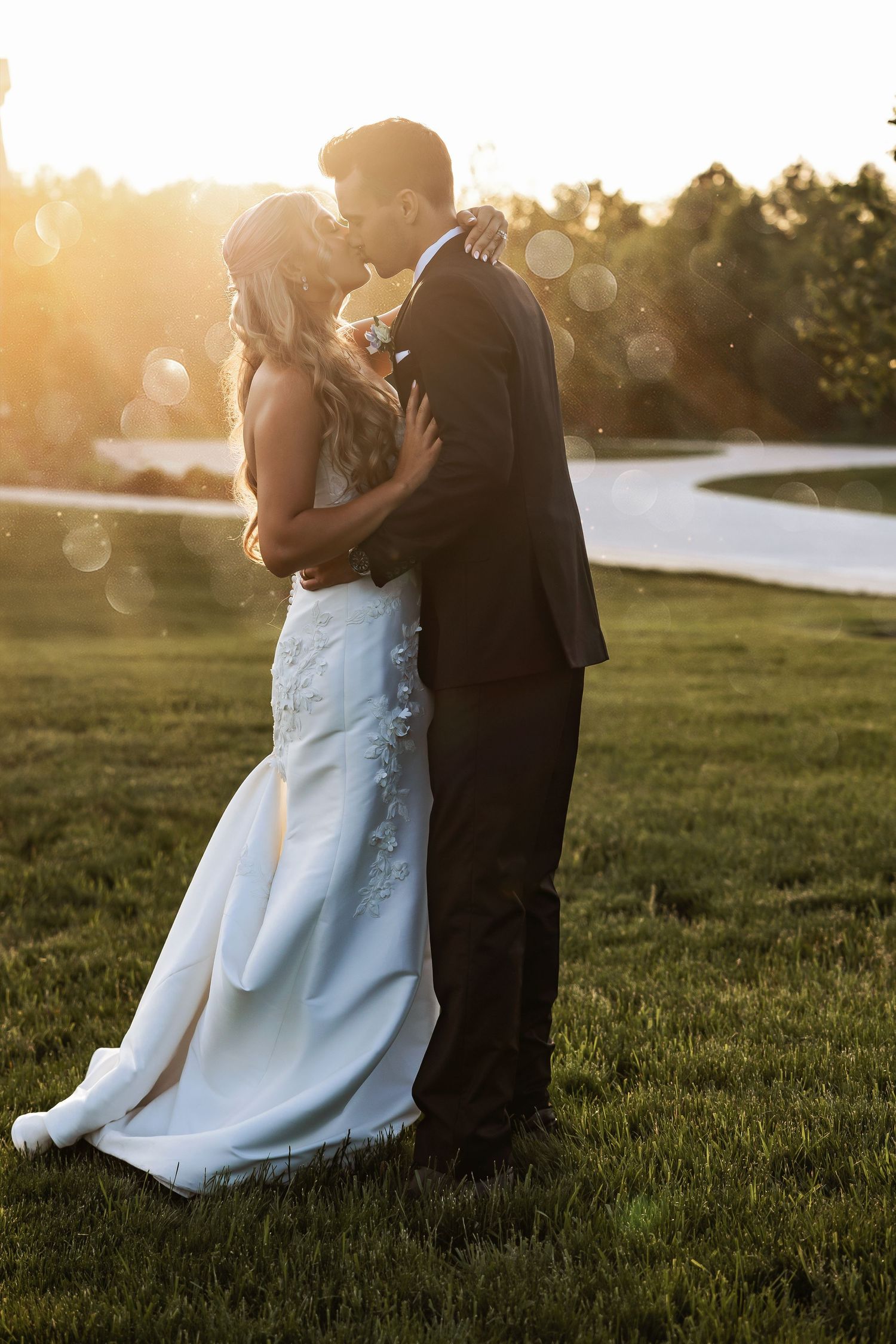 Bride and groom embrace in golden hour light at White Birch Wedding Barn by Rachel Martinez Photography, Michigan wedding photographer