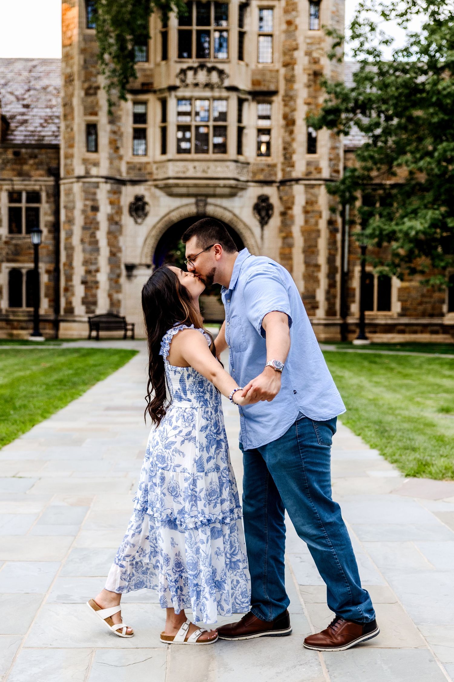 Couple holds hands and kisses in the UM Law Quadby Rachel Martinez Photography, Michigan Wedding photographer