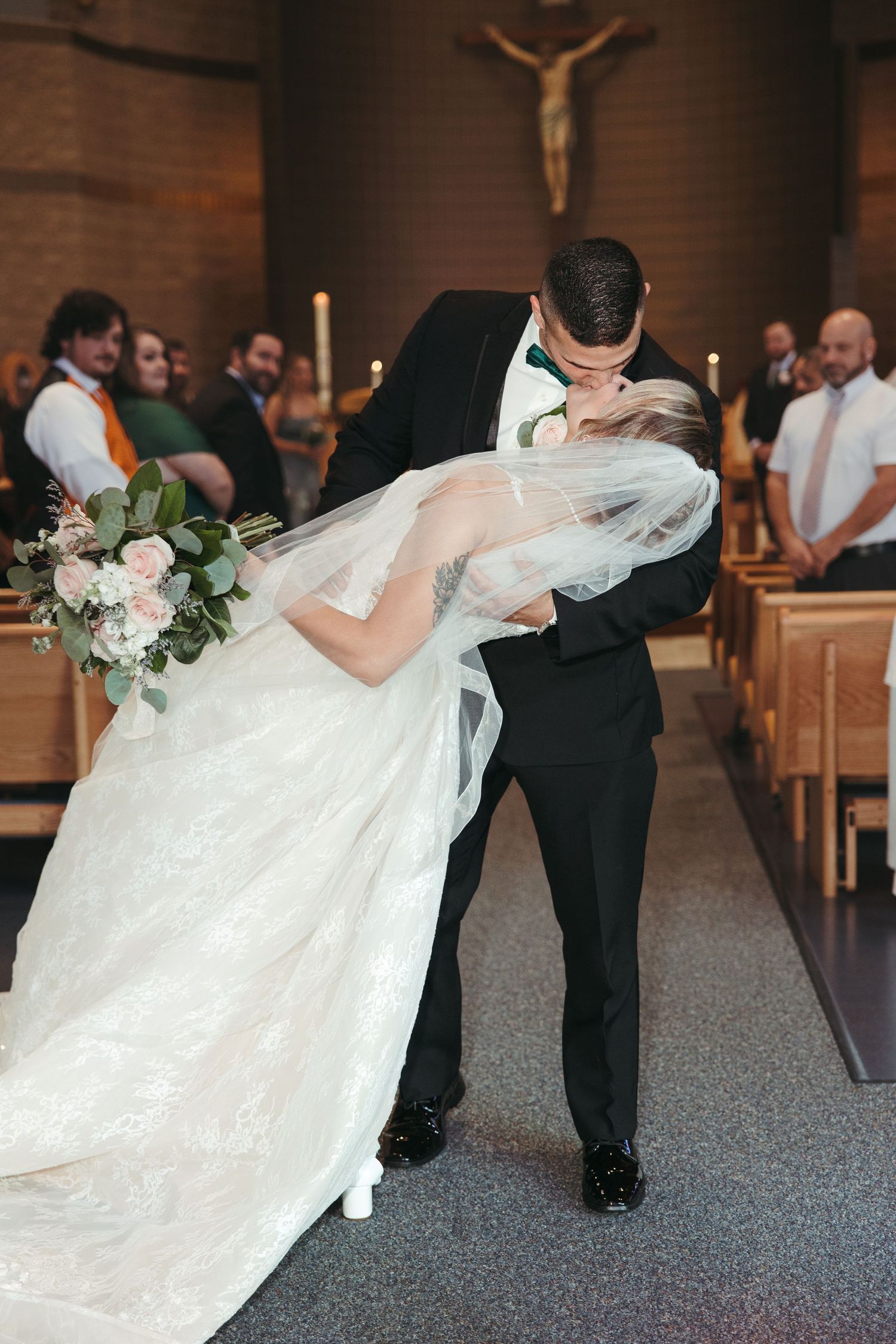 Couple dips for a kiss at a church on Detroit's East Side at their wedding by Rachel Martinez Photography, Michigan wedding photographer