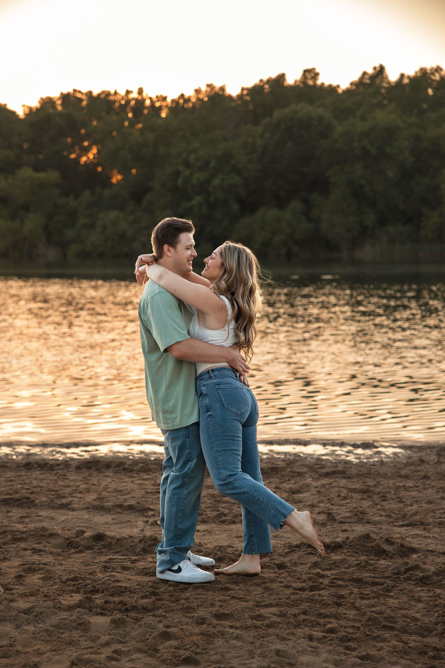 Couple embraces in the sand at Island Lake State Park by Engagement Photographer Rachel Martinez Photography