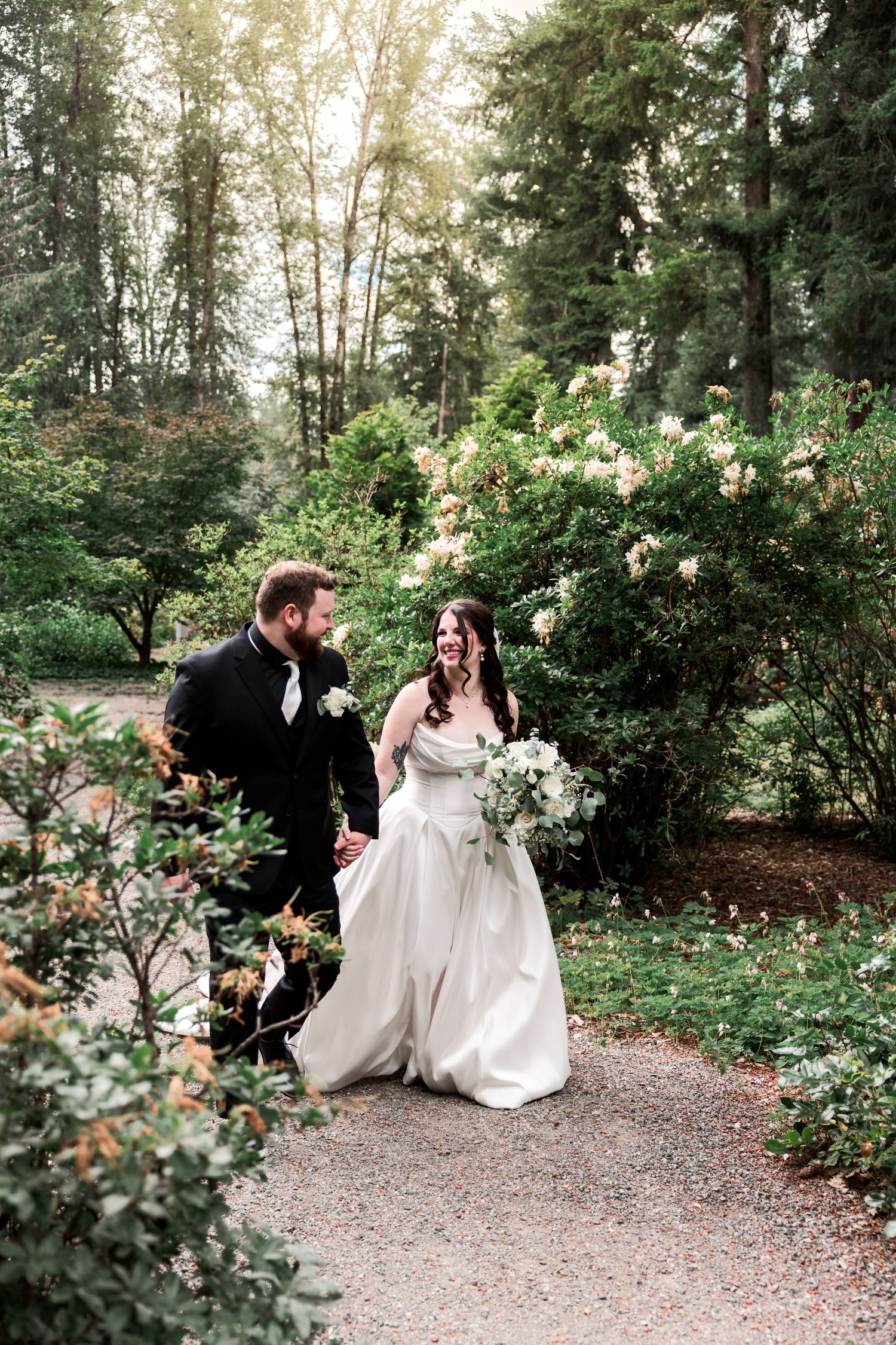 Couple strolls through forest path during their wedding in Seattle Washington by Rachel Martinez Photography, Michigan wedding photographer