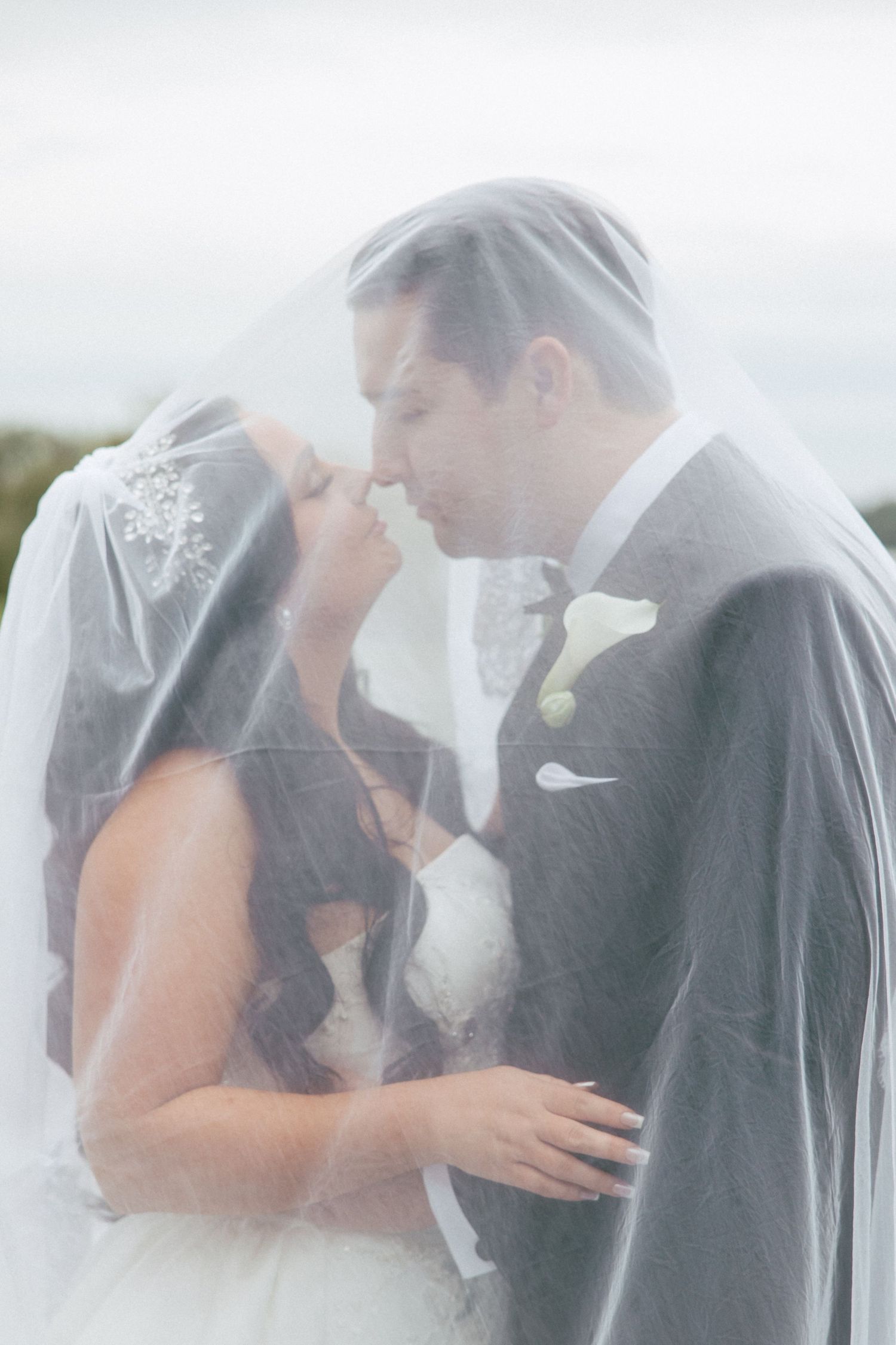 Couple looks at each other under veil in Metro Detroit on their wedding day by Rachel Martinez Photography, Michigan wedding photographer