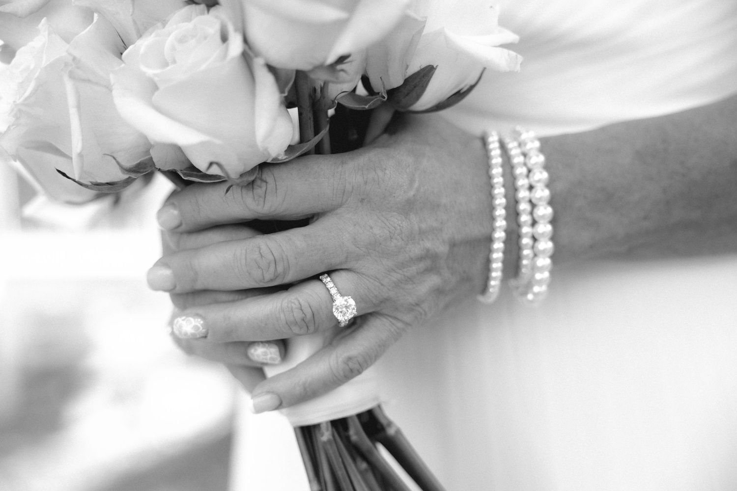 Close up of engagement ring while bride holds her bouquet at Victoria Wedding Chapel in Waterford by wedding photographer Rachel Martinez