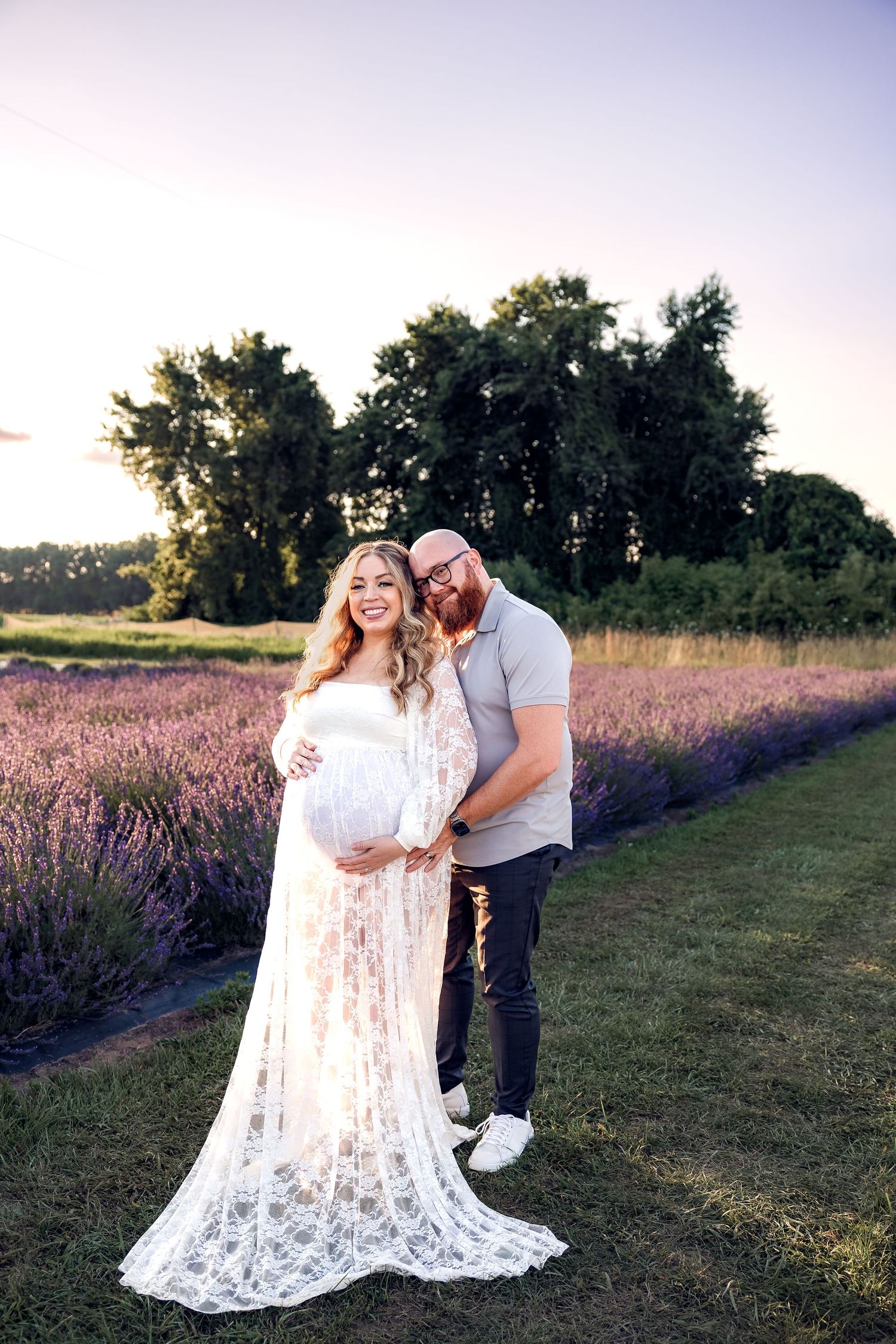 Couple embraces in golden light in Milan Michigan by family photographer Rachel Martinez