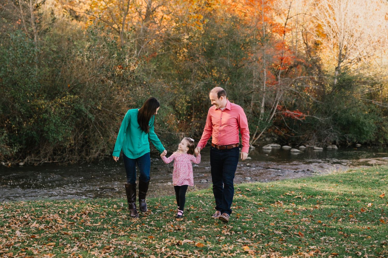 Family of three walks along the water in Northville Michigan by Rachel Martinez Photography, Michigan photographer