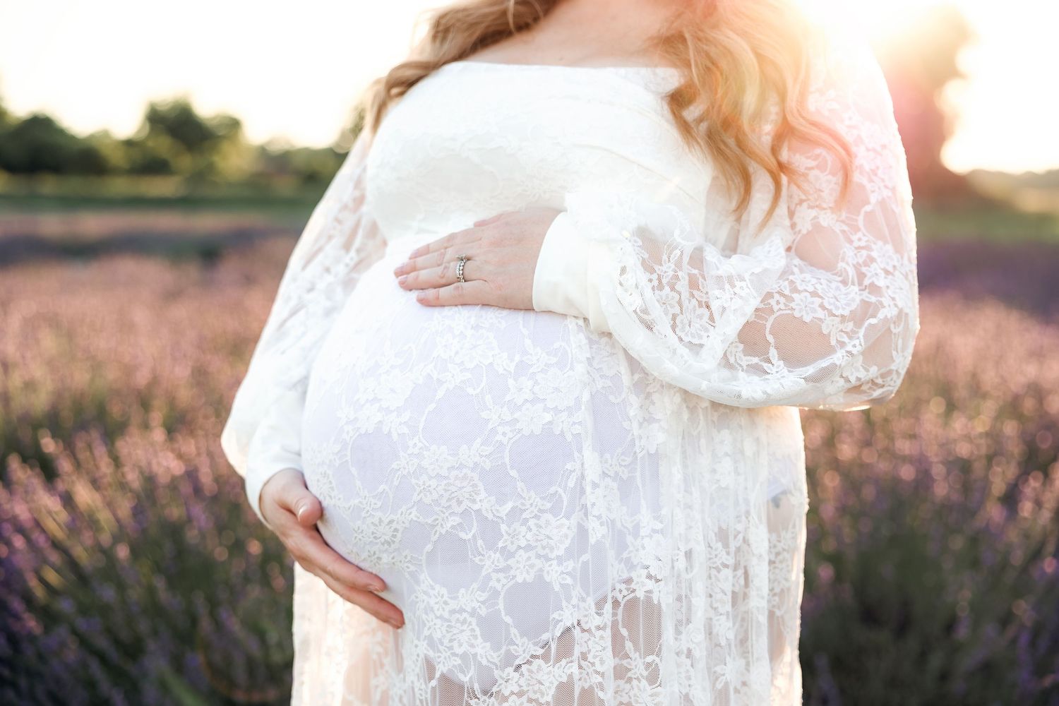 Close up of maternity belly in golden light in Milan Michigan by family photographer Rachel Martinez