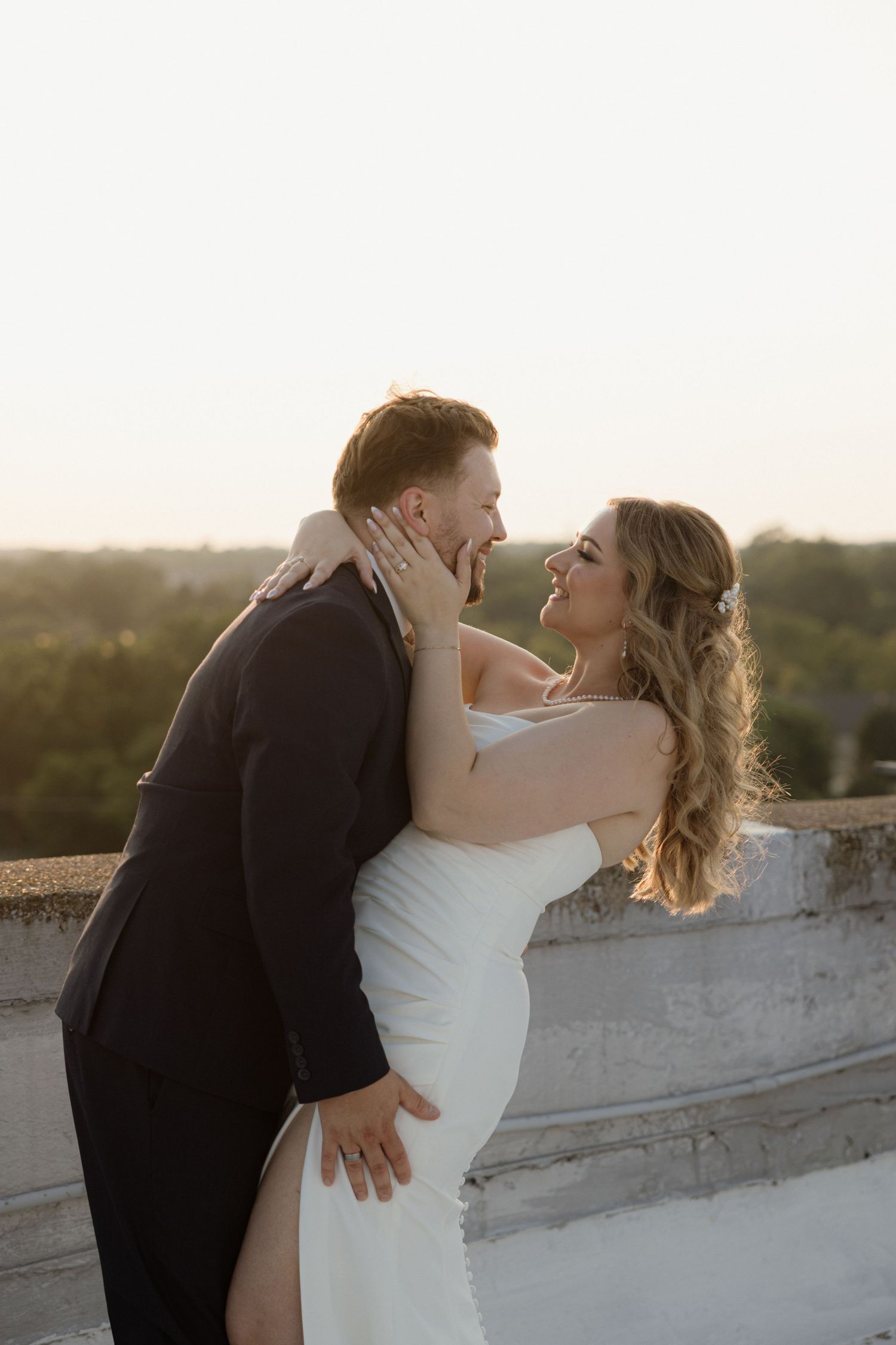 Couple embraces on the roof of the Lafayette Grand in Pontiac Michigan by wedding photographer Rachel Martinez Photography