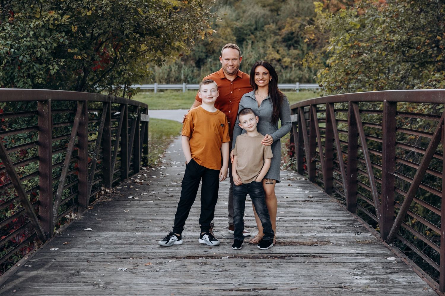 Family of four poses on bridge in Northville Michigan by Rachel Martinez Photography, Michigan photographer