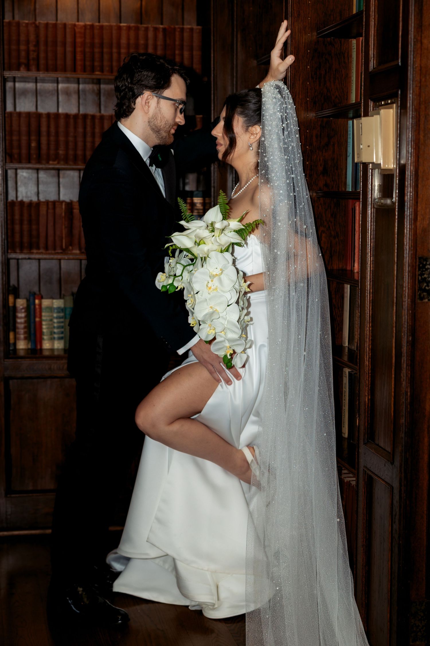 Couple poses in the library of Pine Knob Mansion by wedding photographer Rachel Martinez Photography Novi, Michigan