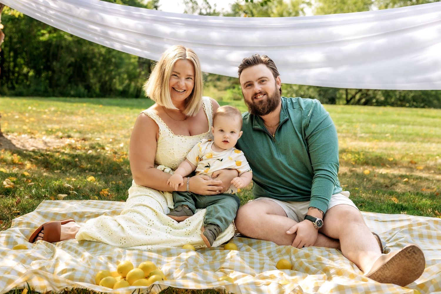 Family of three poses during mini session in Novi Michigan by Rachel Martinez Photography