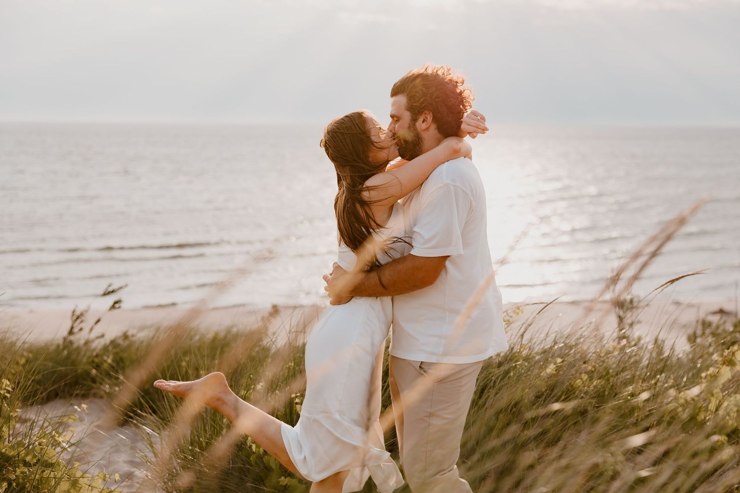 Couple kisses in the sunlight at Silver Lake Sand Dunes on Lake Michigan by Rachel Martinez Photography, Michigan Wedding photographer