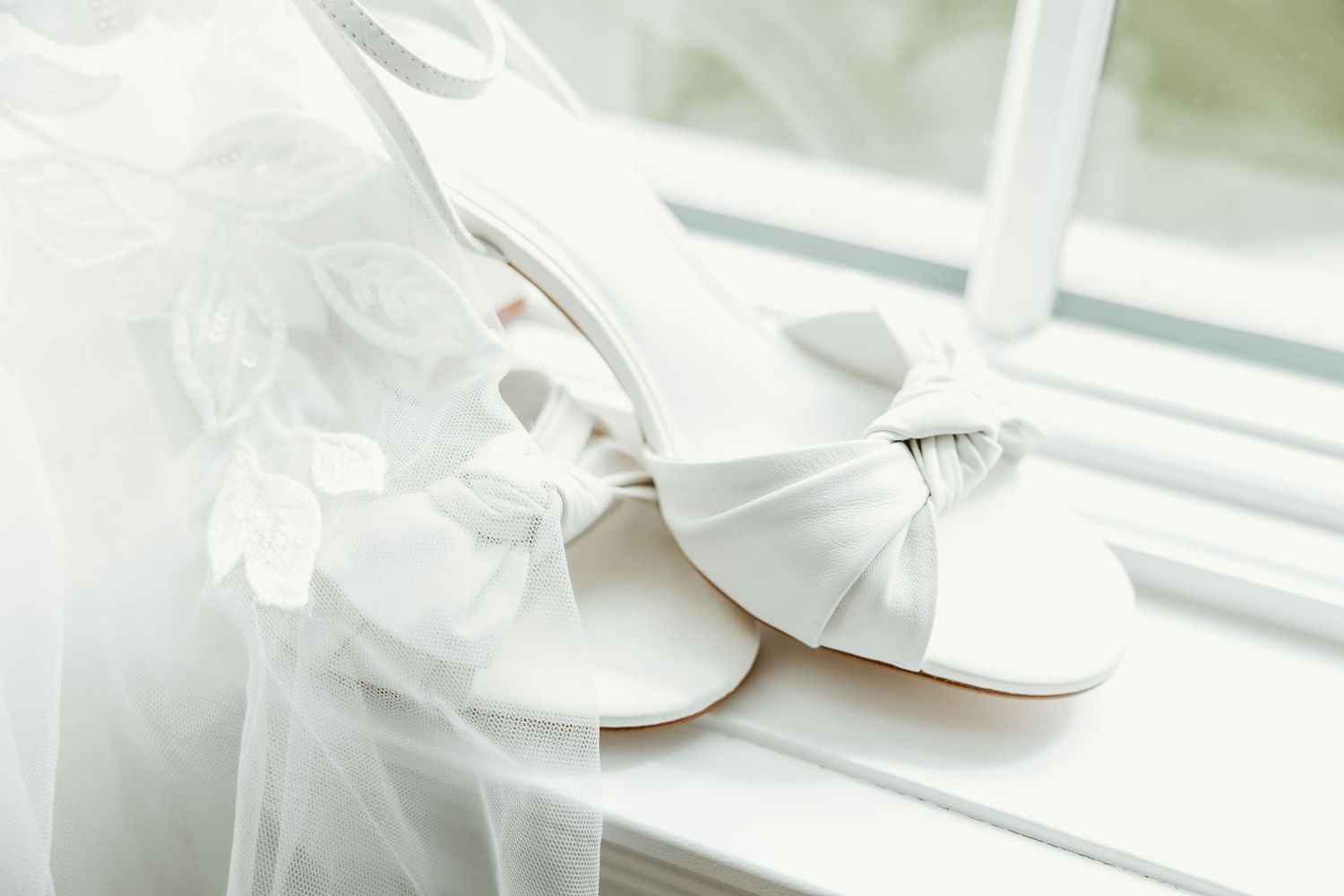 Bridal shoes sit on a windowsill at the St. Clair Inn by wedding photographer Rachel Martinez Photography Novi, Michigan