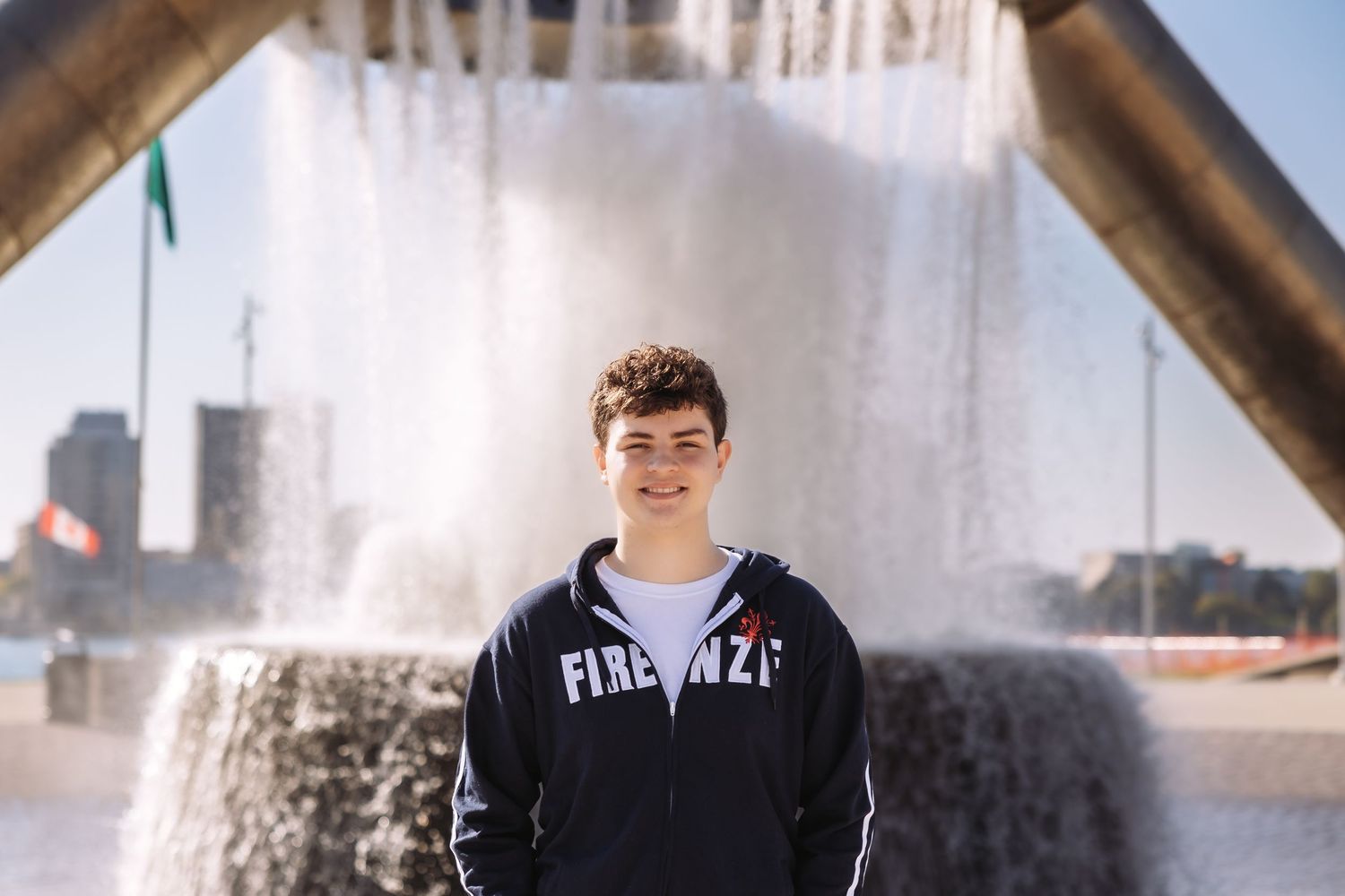 Senior boy poses by fountain in downtown Detroit by Rachel Martinez Photography, Michigan photographer