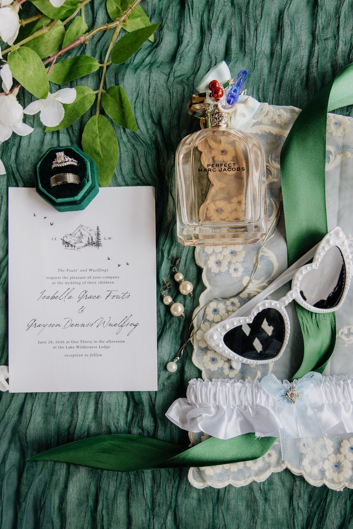 Flat lay of details perfume sunnies invitation rings garter by wedding photographer Rachel Martinez Photography Novi, Michigan