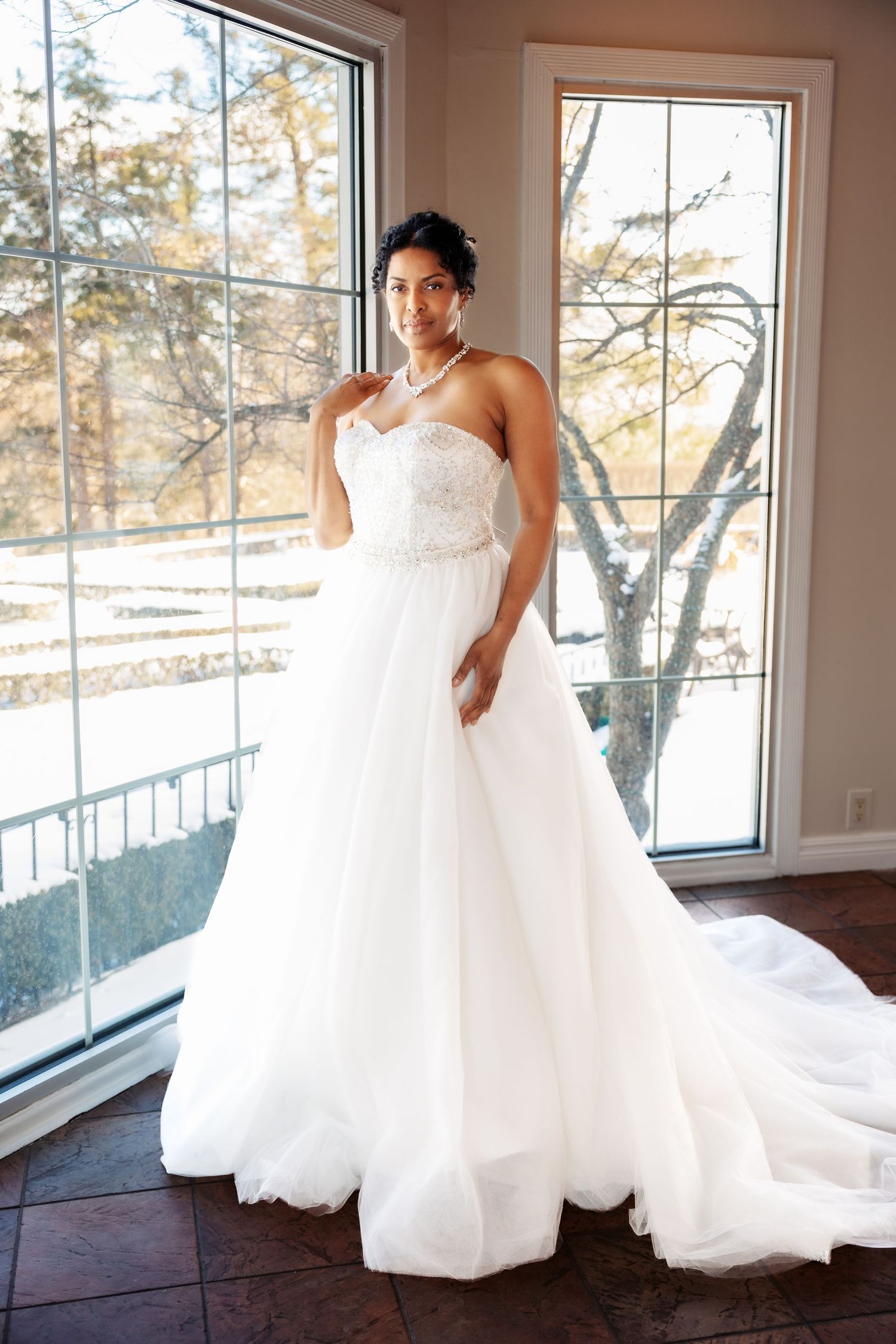 Bride poses at Pine Knob Mansion by open windows by Rachel Martinez Photography, Michigan wedding photographer