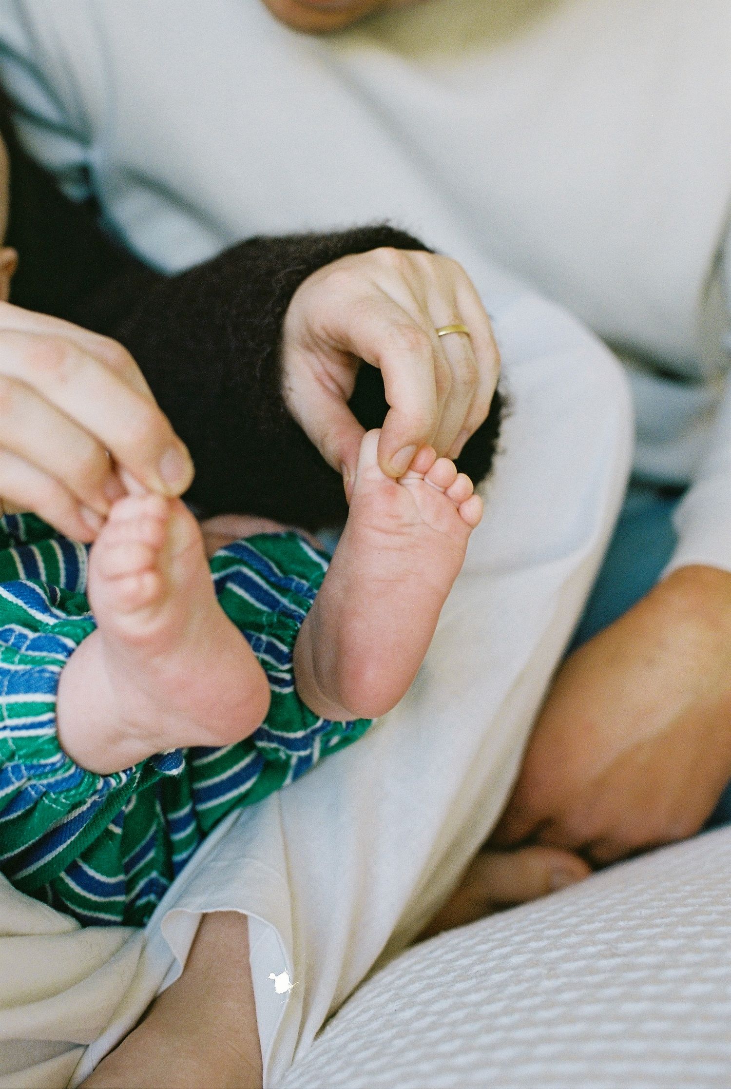 mum playing with baby's toes captured on 35mm film