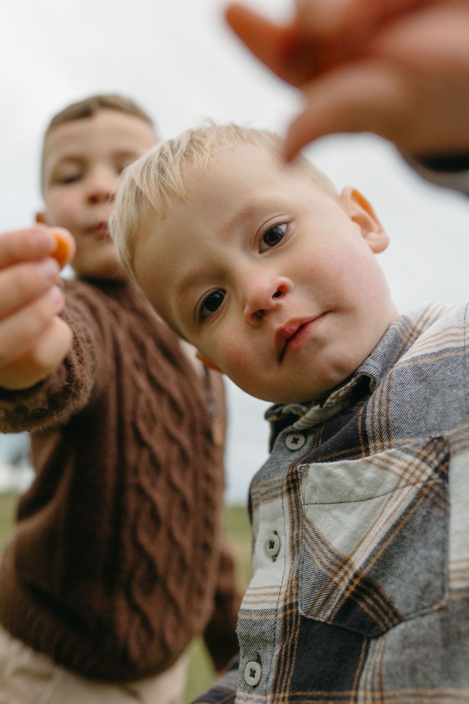 two kids showing smarties to the camera