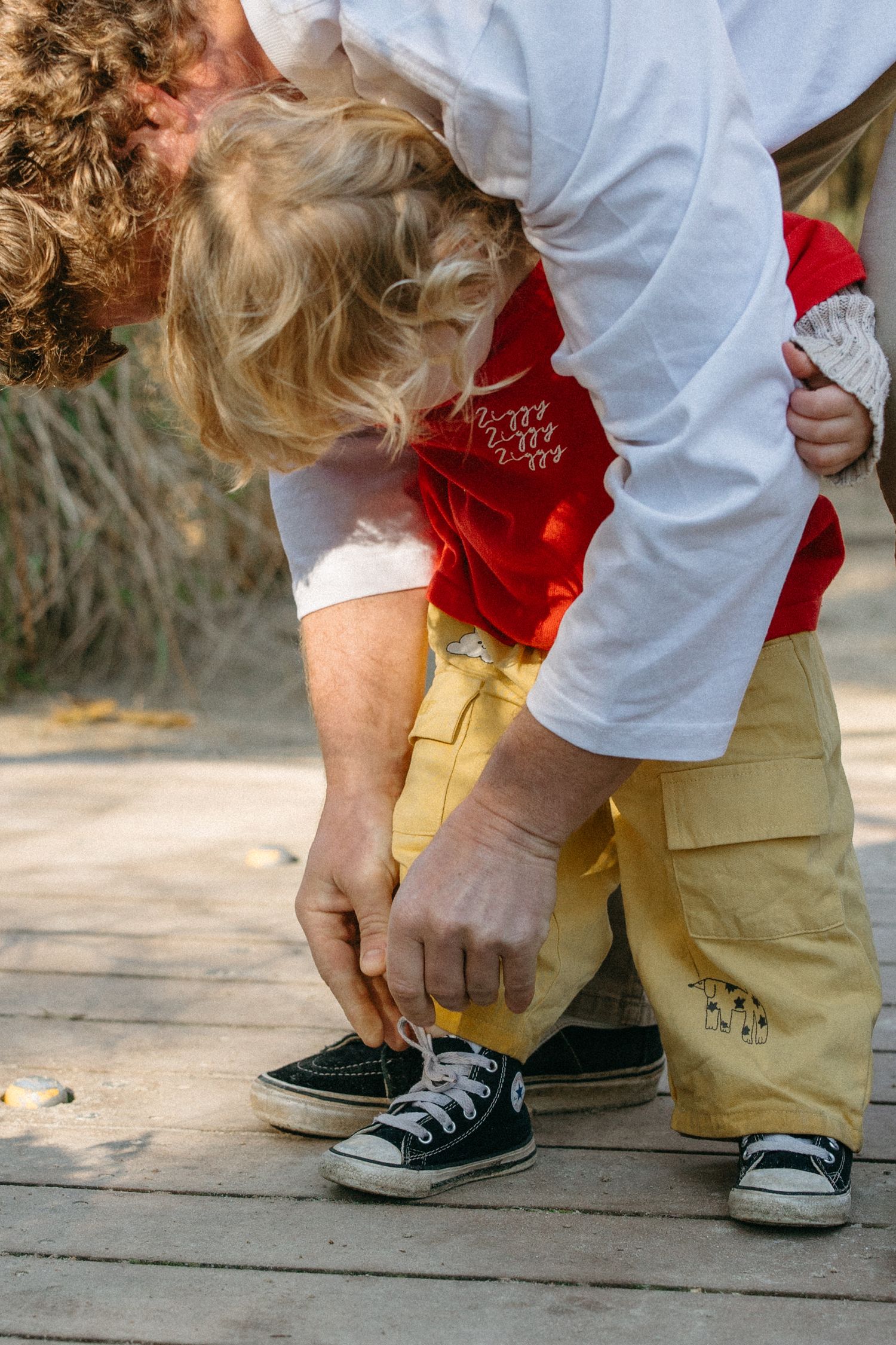 dad trying sons shoelaces