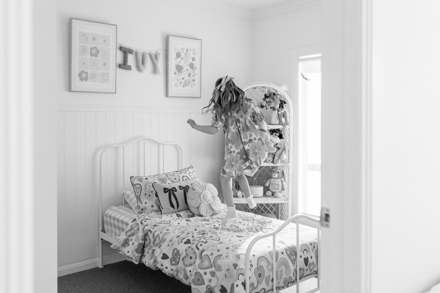 girl bouncing on her bed