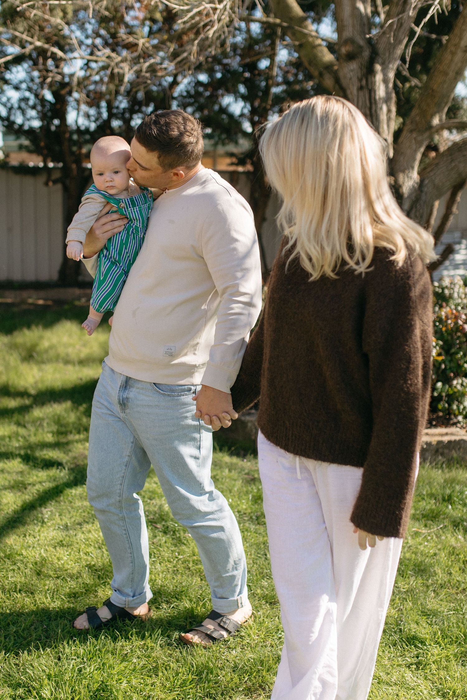 family walking in their backyard