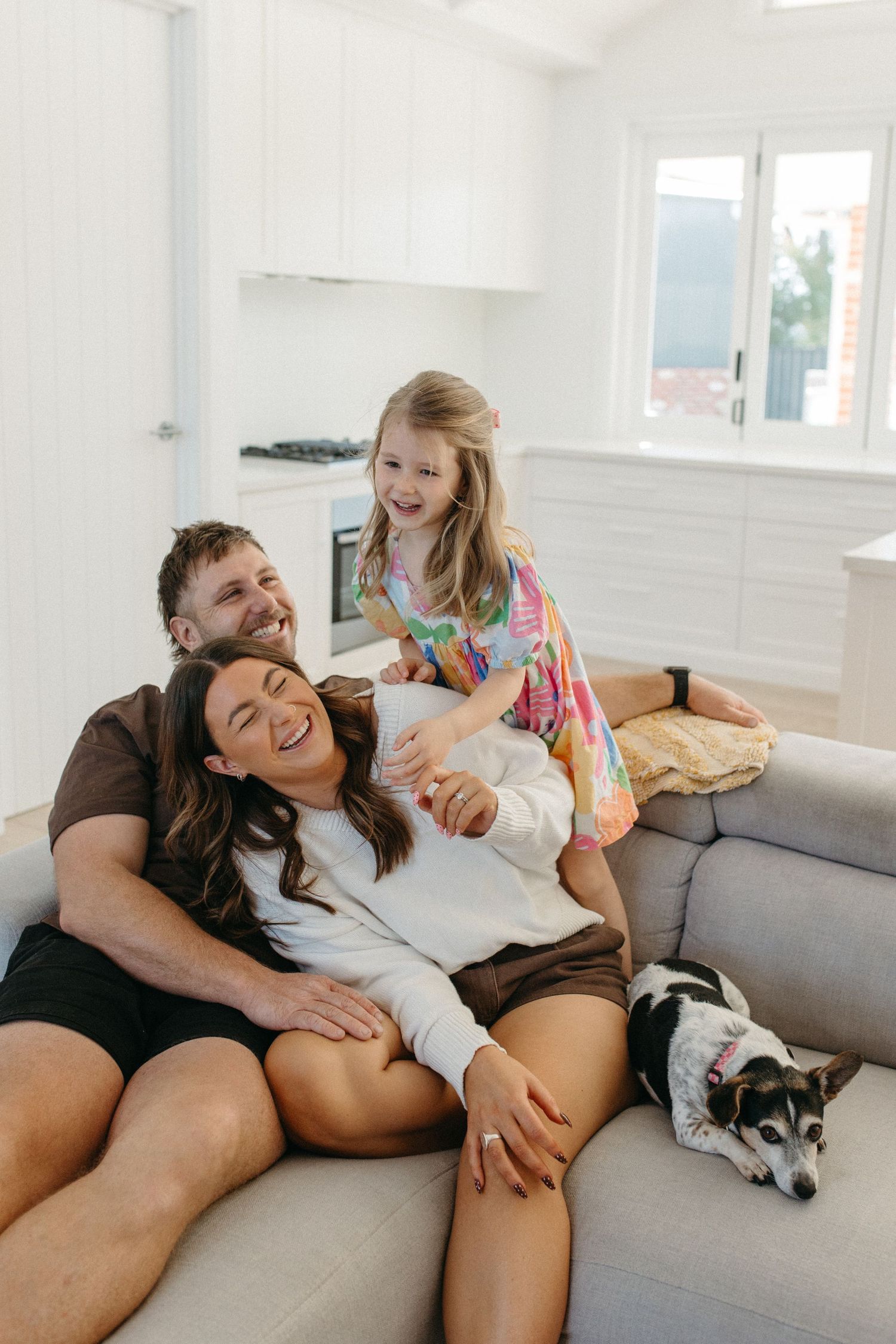 family cuddling on a couch