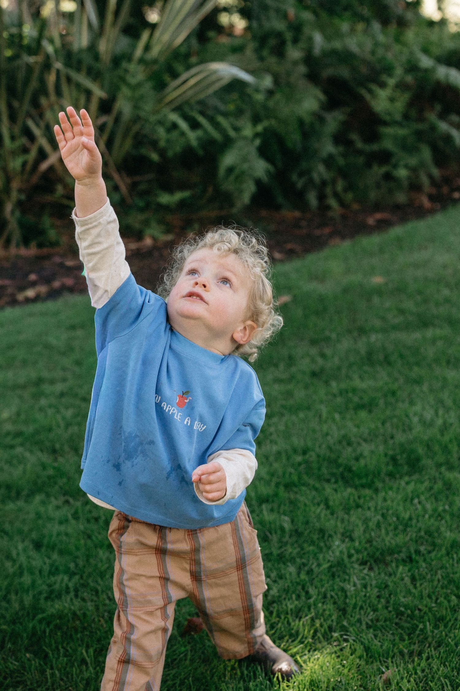 boy posing and pointing into the air