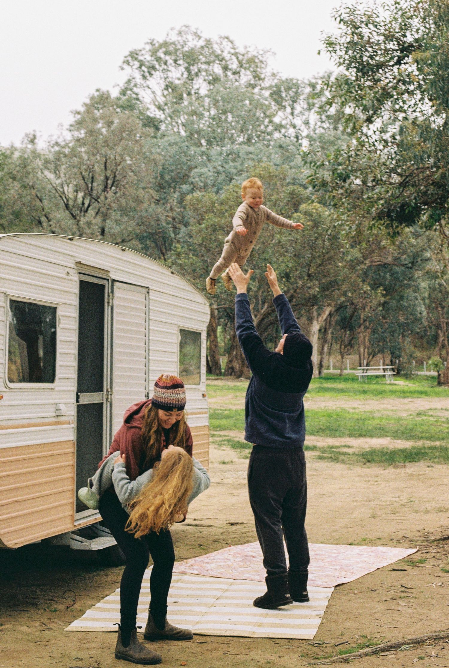 family playing outside caravan captured on 35mm film