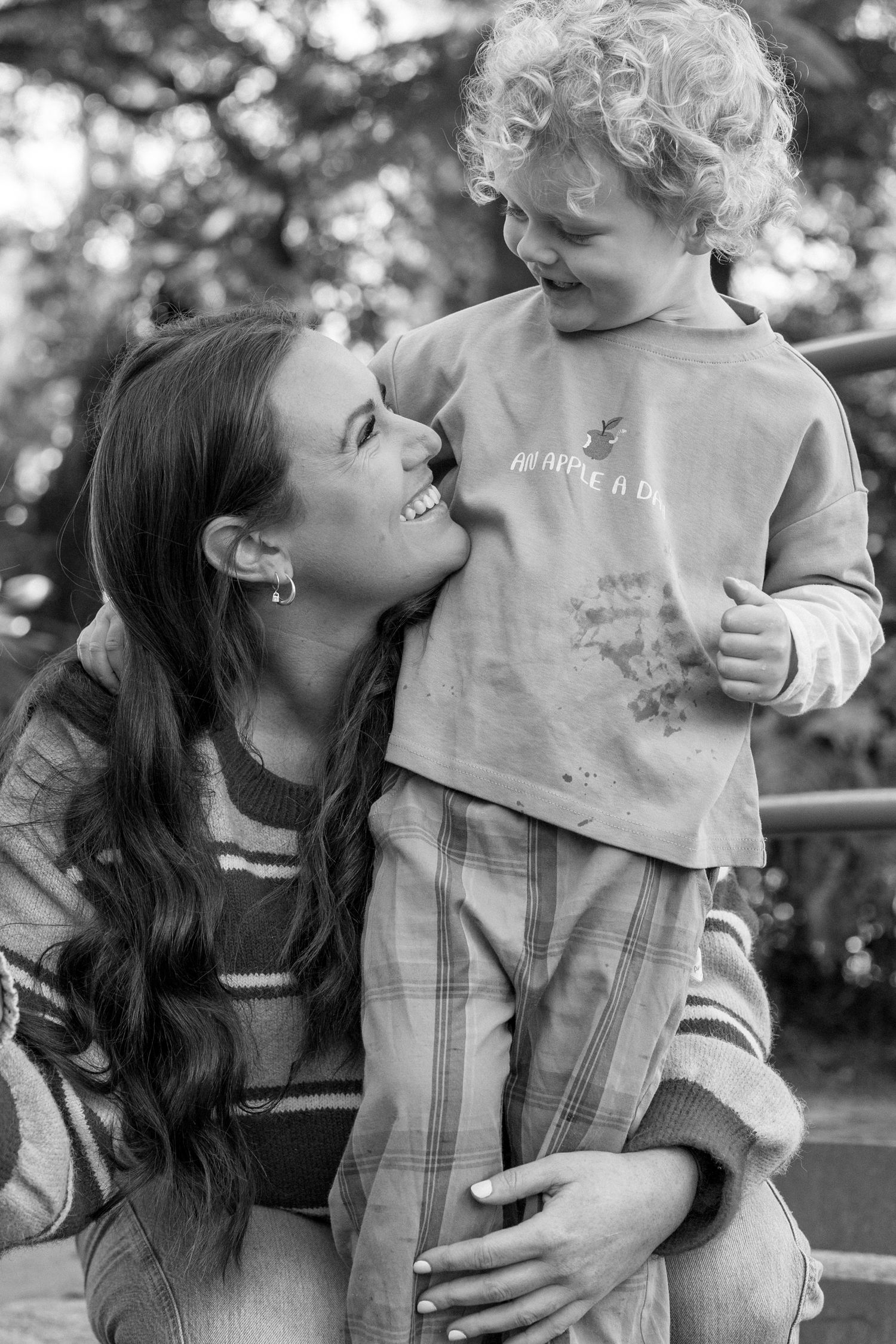 son cuddling mother outside
