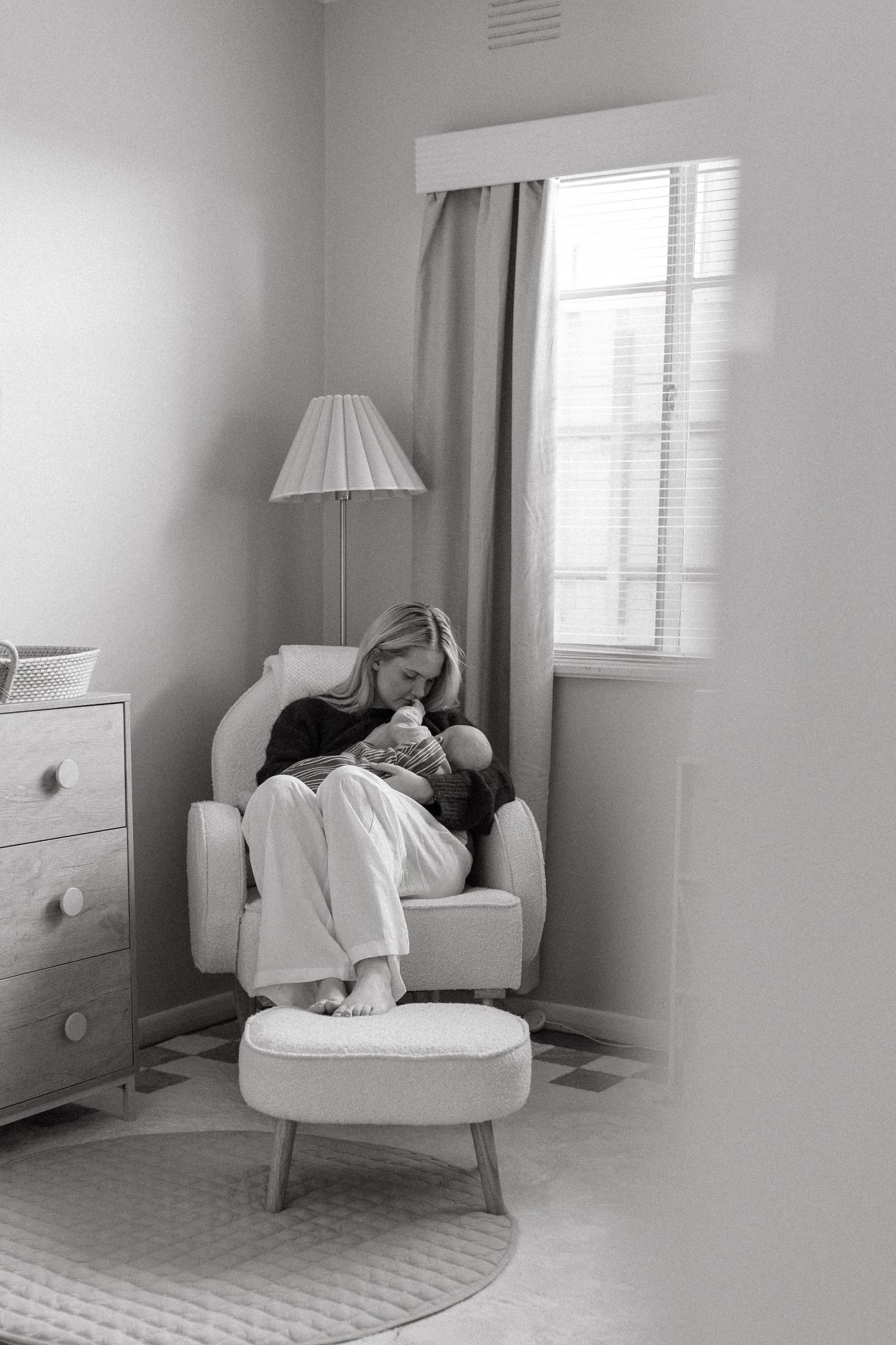 woman breastfeeding her baby in a rocking chair