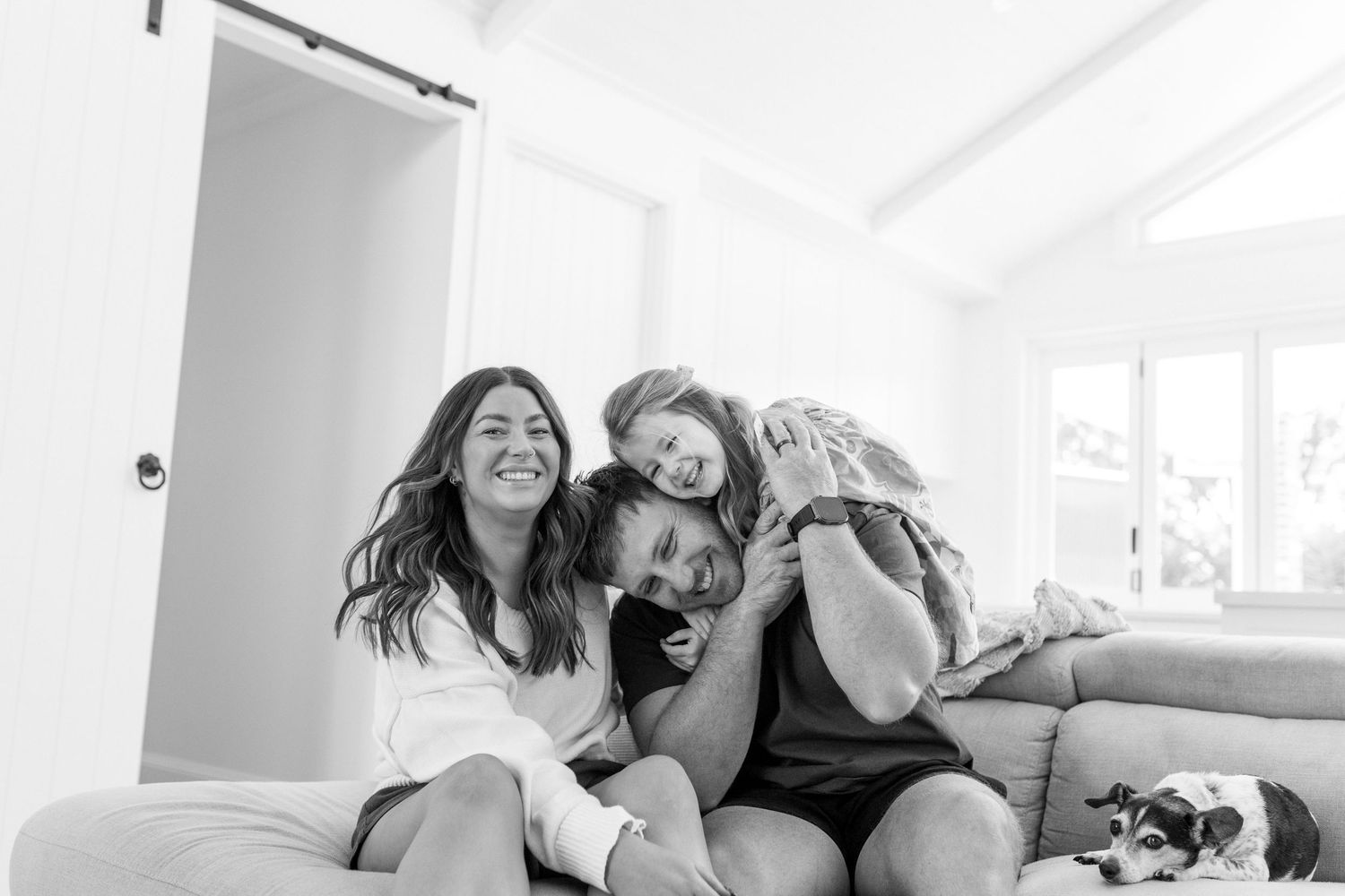 family cuddling on a couch