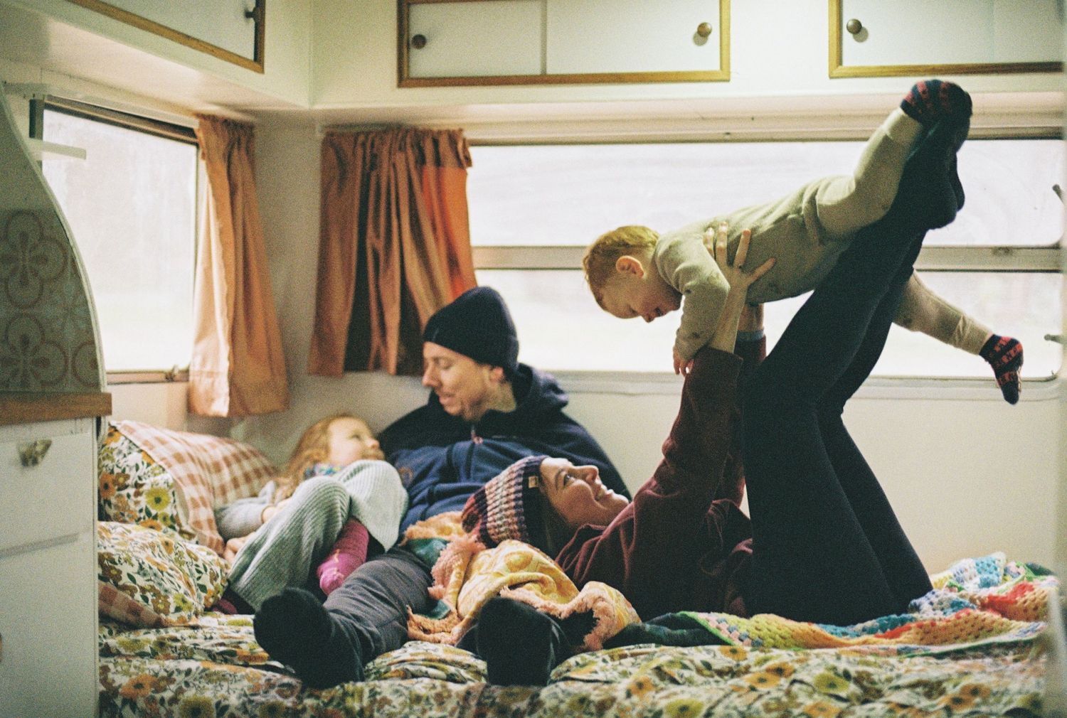 family playing inside caravan captured on 35mm film