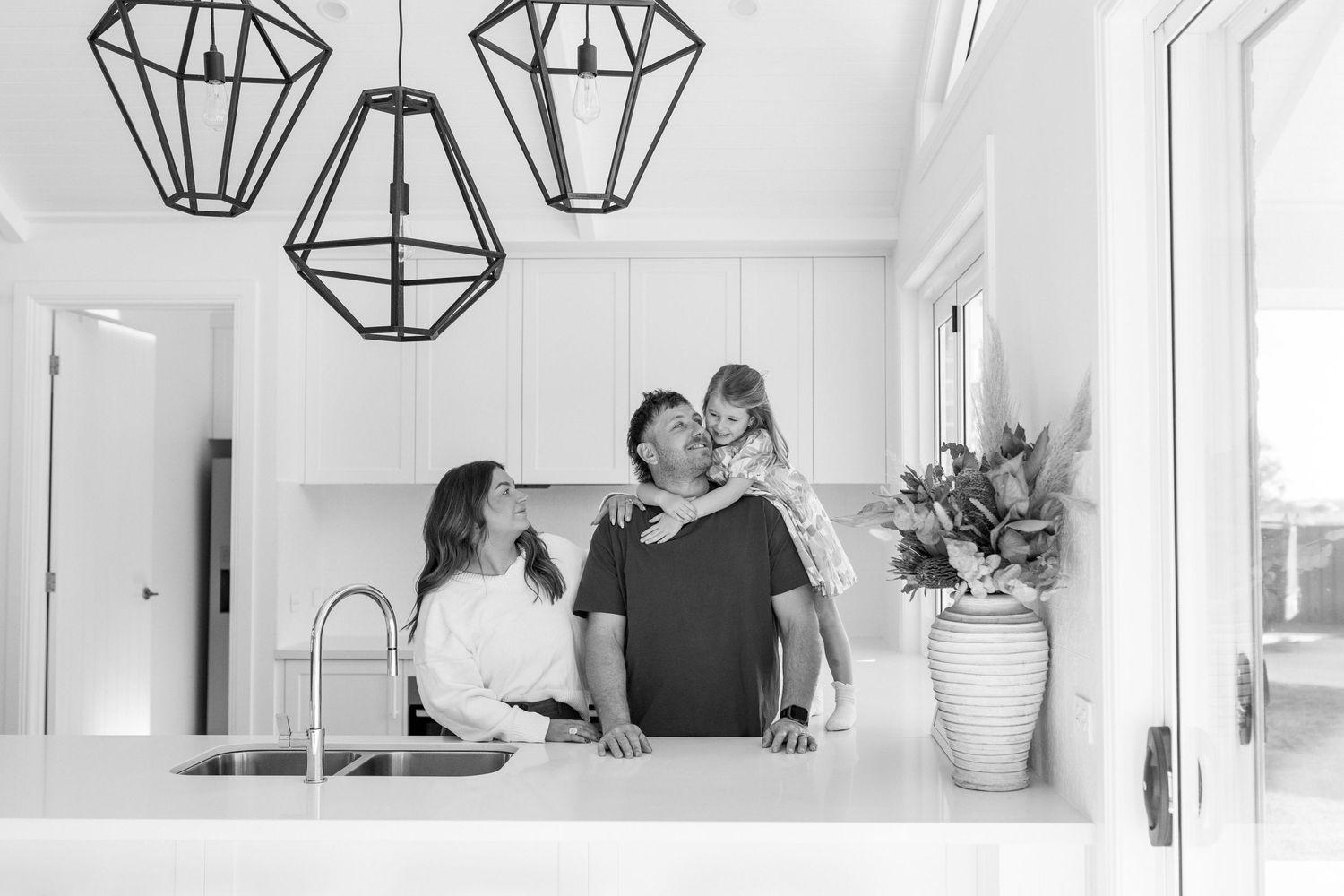 family cuddling in their kitchen