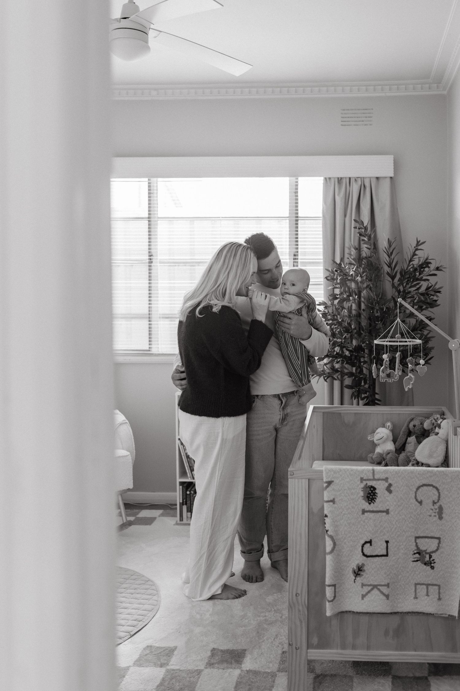 family snuggling in nursery