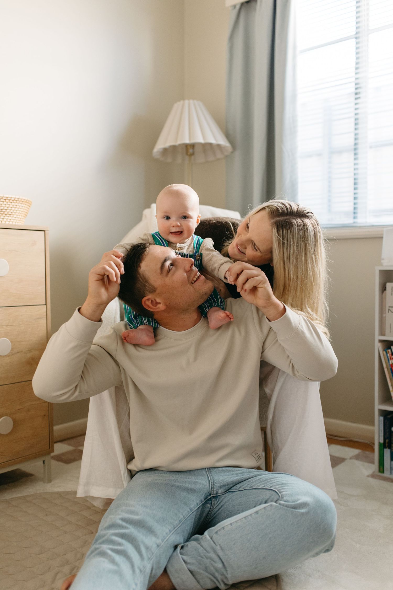 family sitting in baby nursery