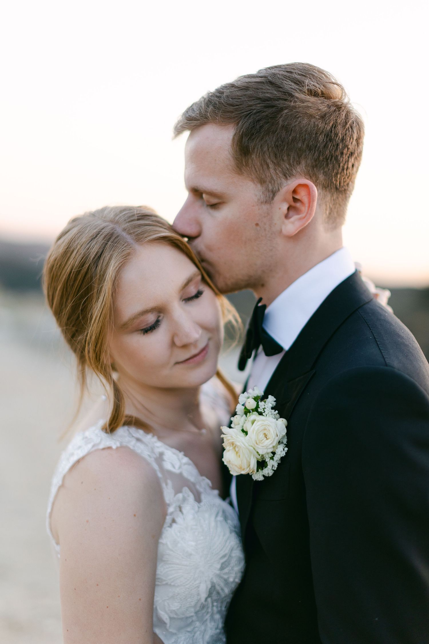 An intimate wedding portrait showing a tender moment between newlyweds in Malibu California.