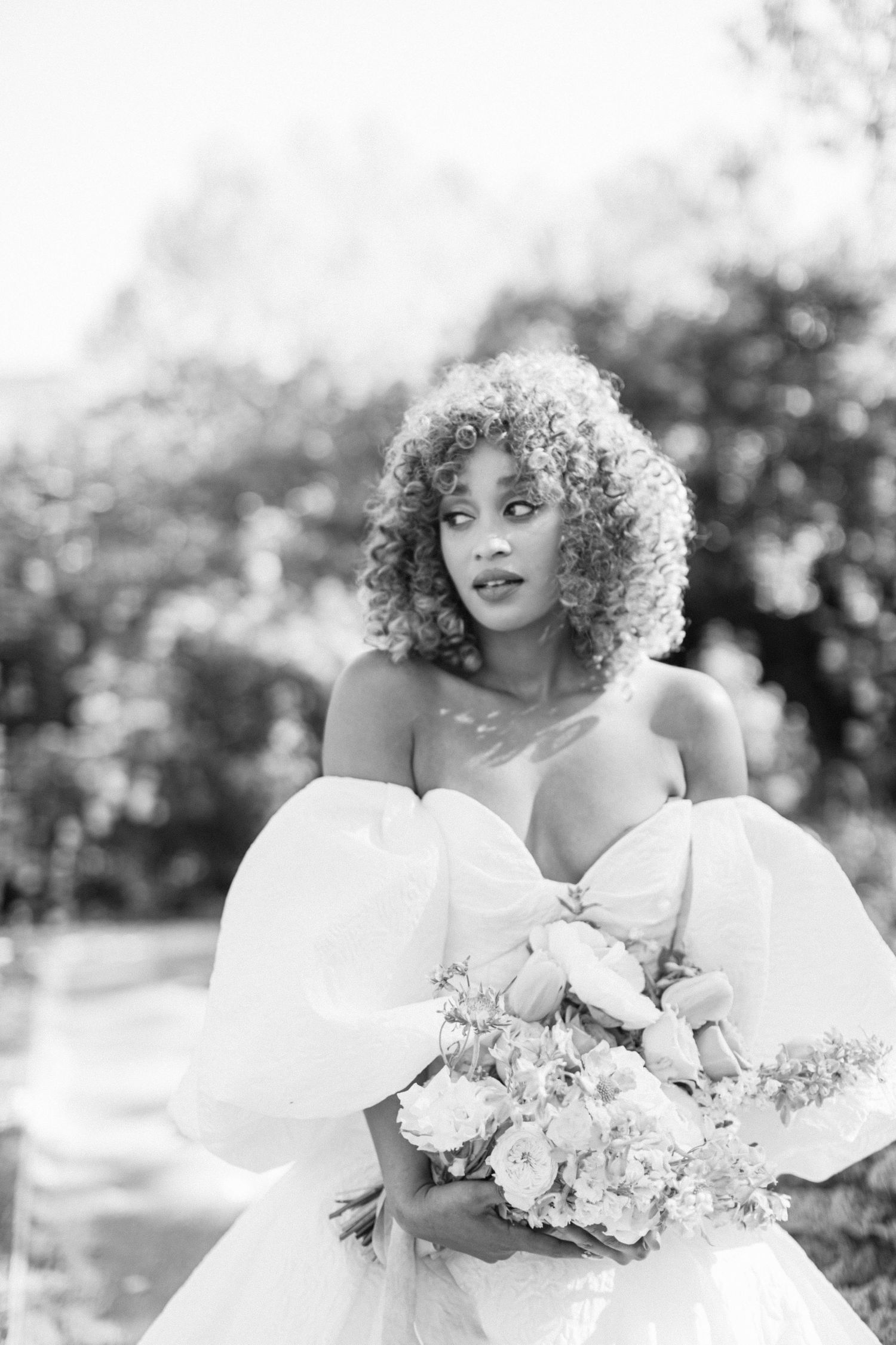 Elegant bridal portraits in black and white featuring a flowing white gown and floral bouquet.