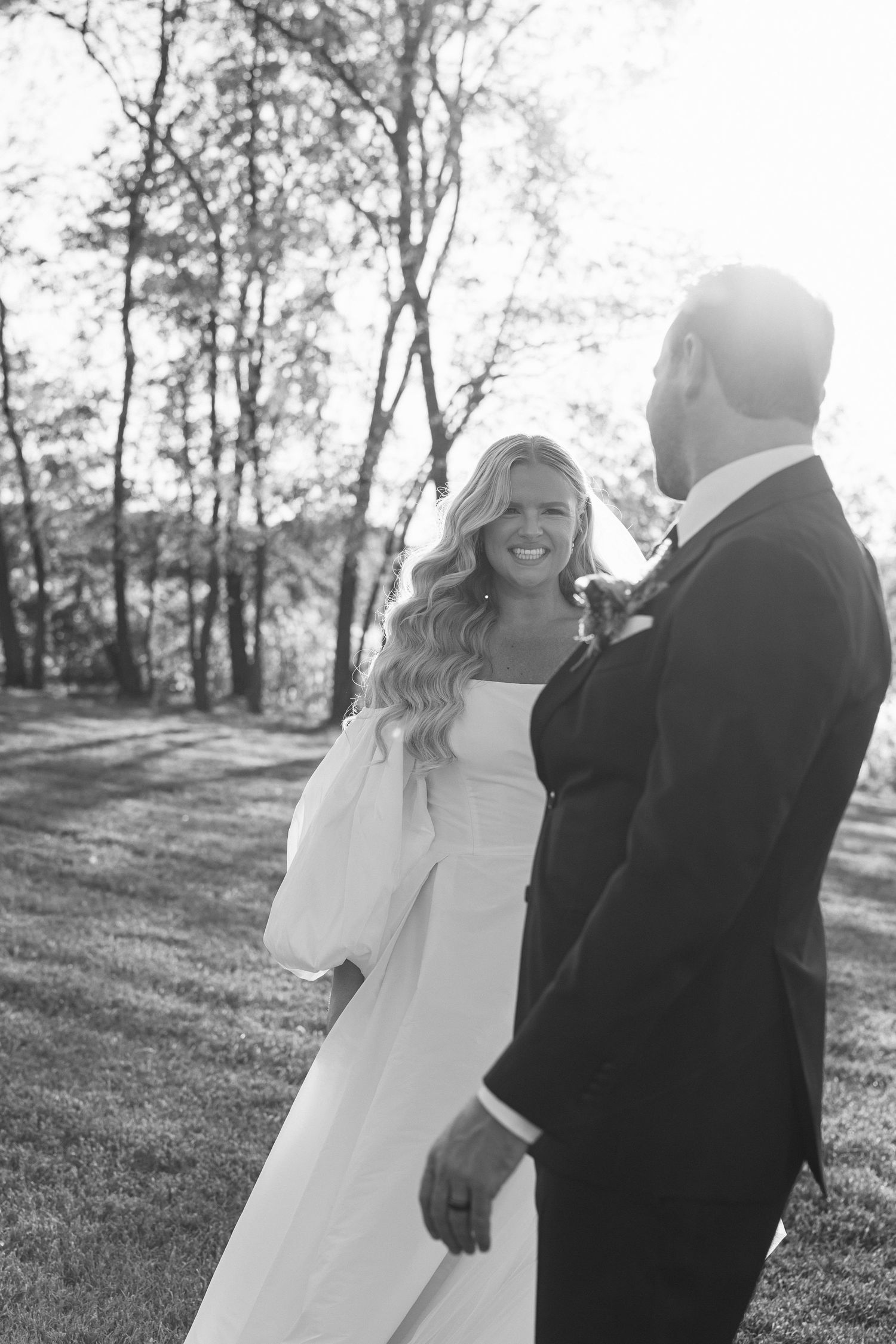 A romantic black and white sunlight photo of bride and groom dancing in the sunlight at bohemian manor farms in Chesapeak Bay Maryland