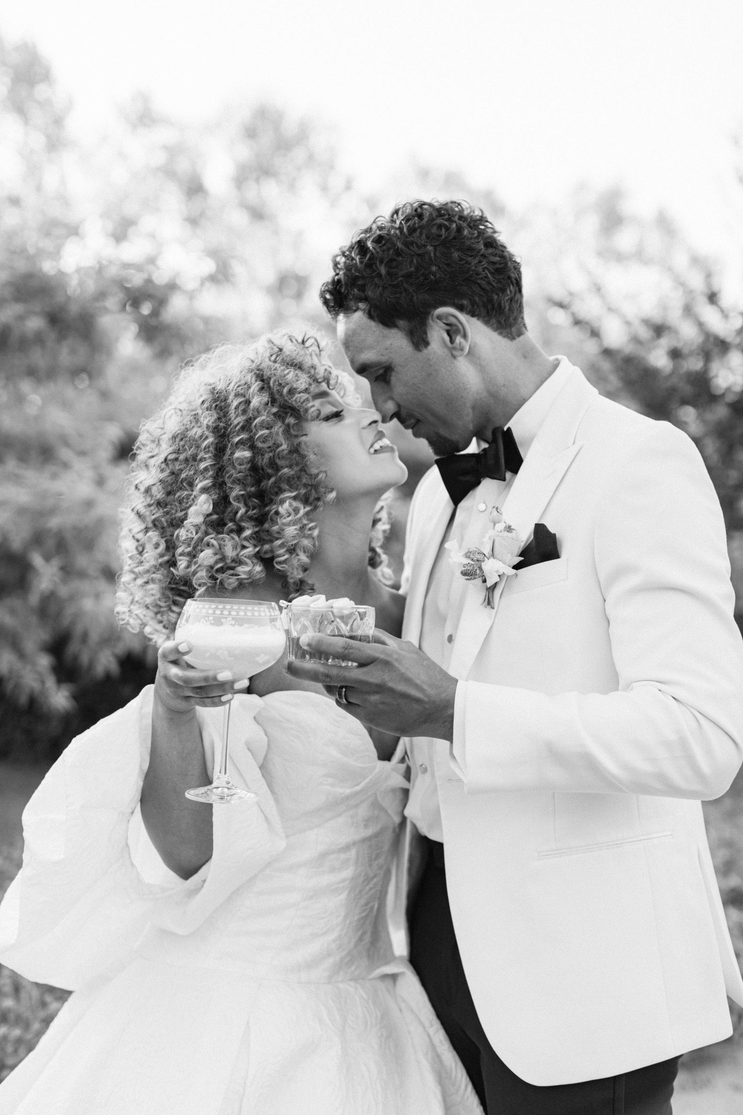 A romantic black and white series of newlyweds sharing champagne together.