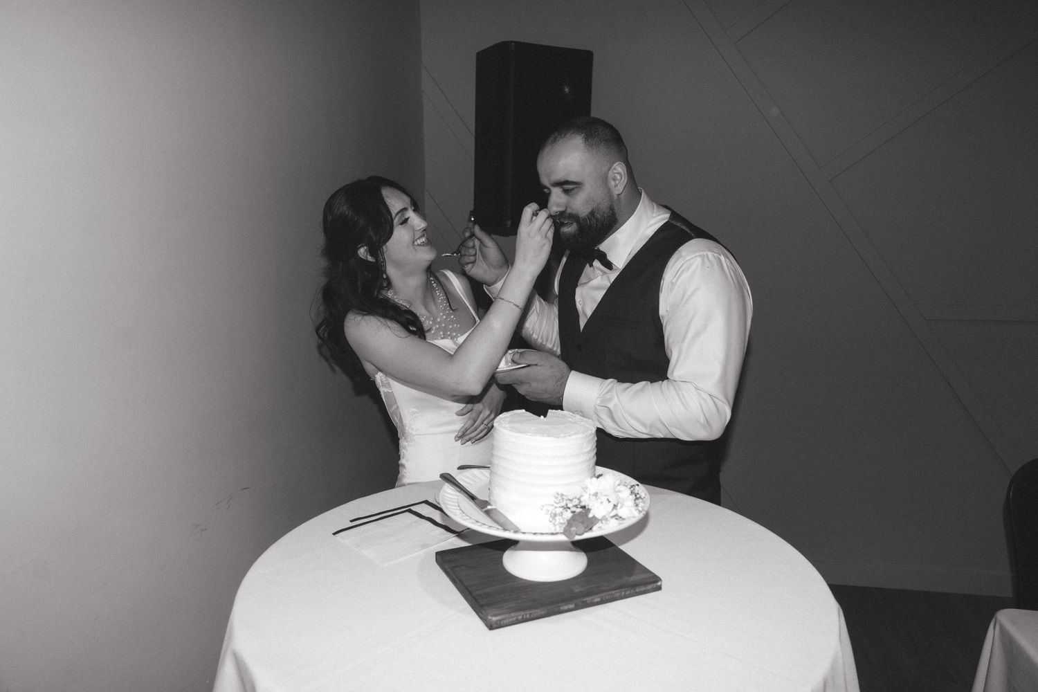 A collection of black and white candid moments from a wedding reception celebration.
