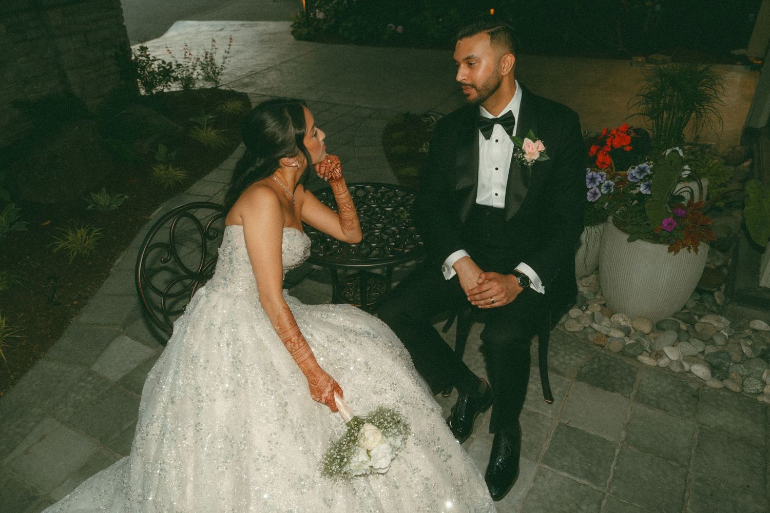 Wedding celebration in dimly lit venue with dancing silhouettes and romantic lighting.