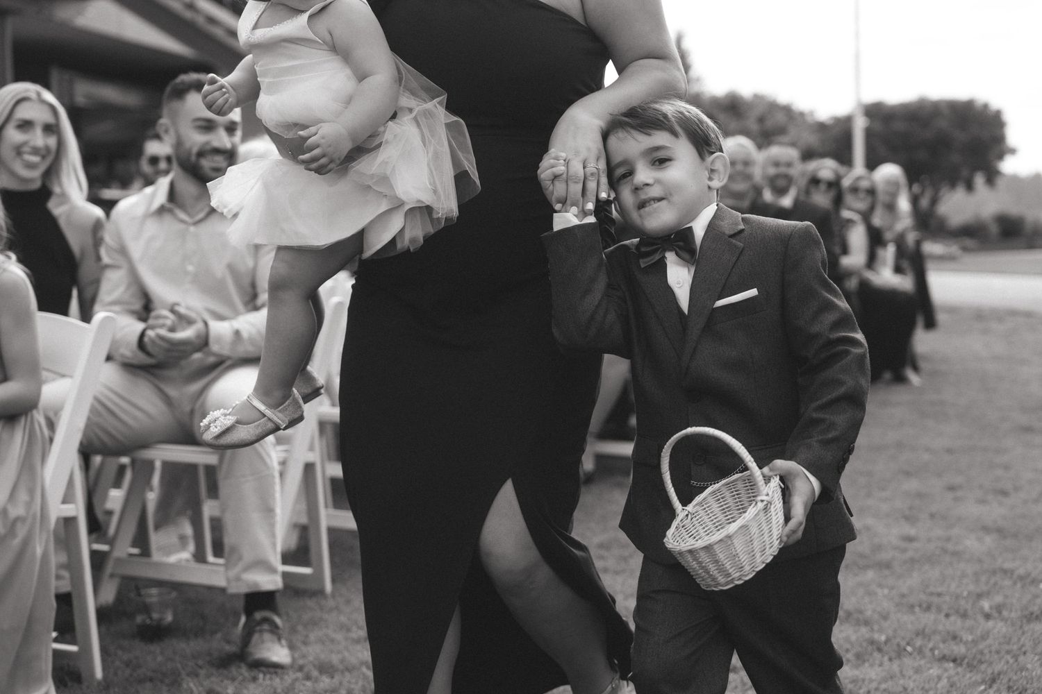 Wedding party celebrates with joyful dance moves at outdoor reception.