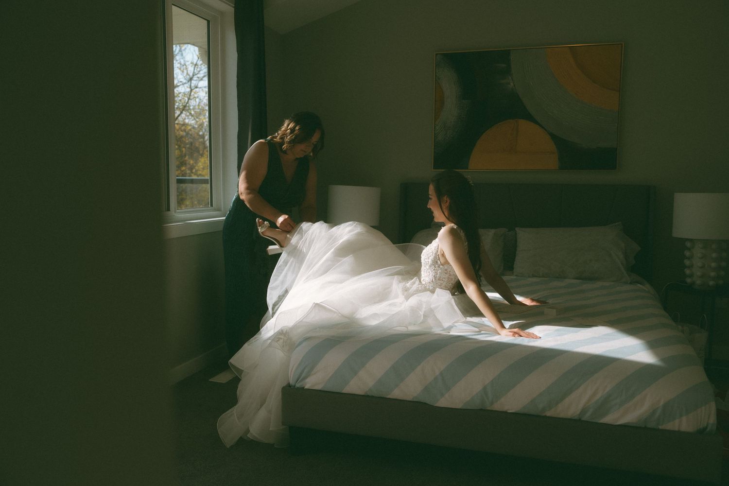 Artistic bridal preparation shots in natural window light.