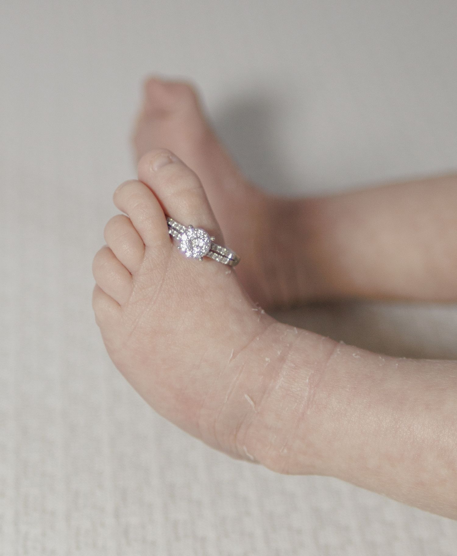 Close-up sequence of a sparkling engagement ring being placed on a woman's finger.