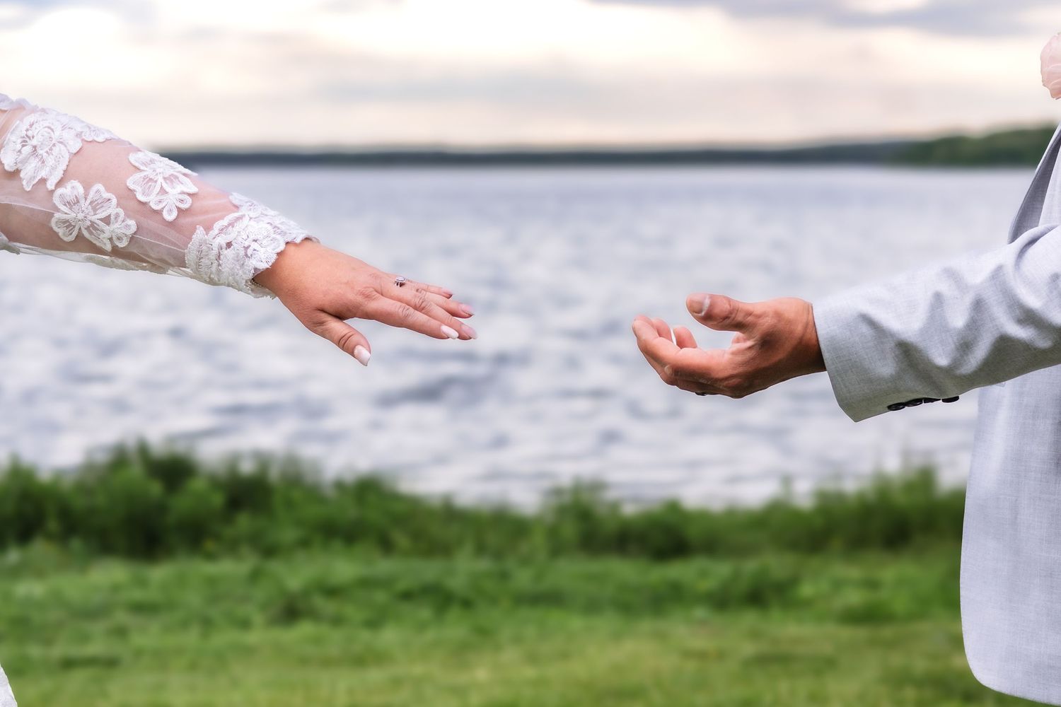 Cropped view of wedding ceremony participants standing outdoors.